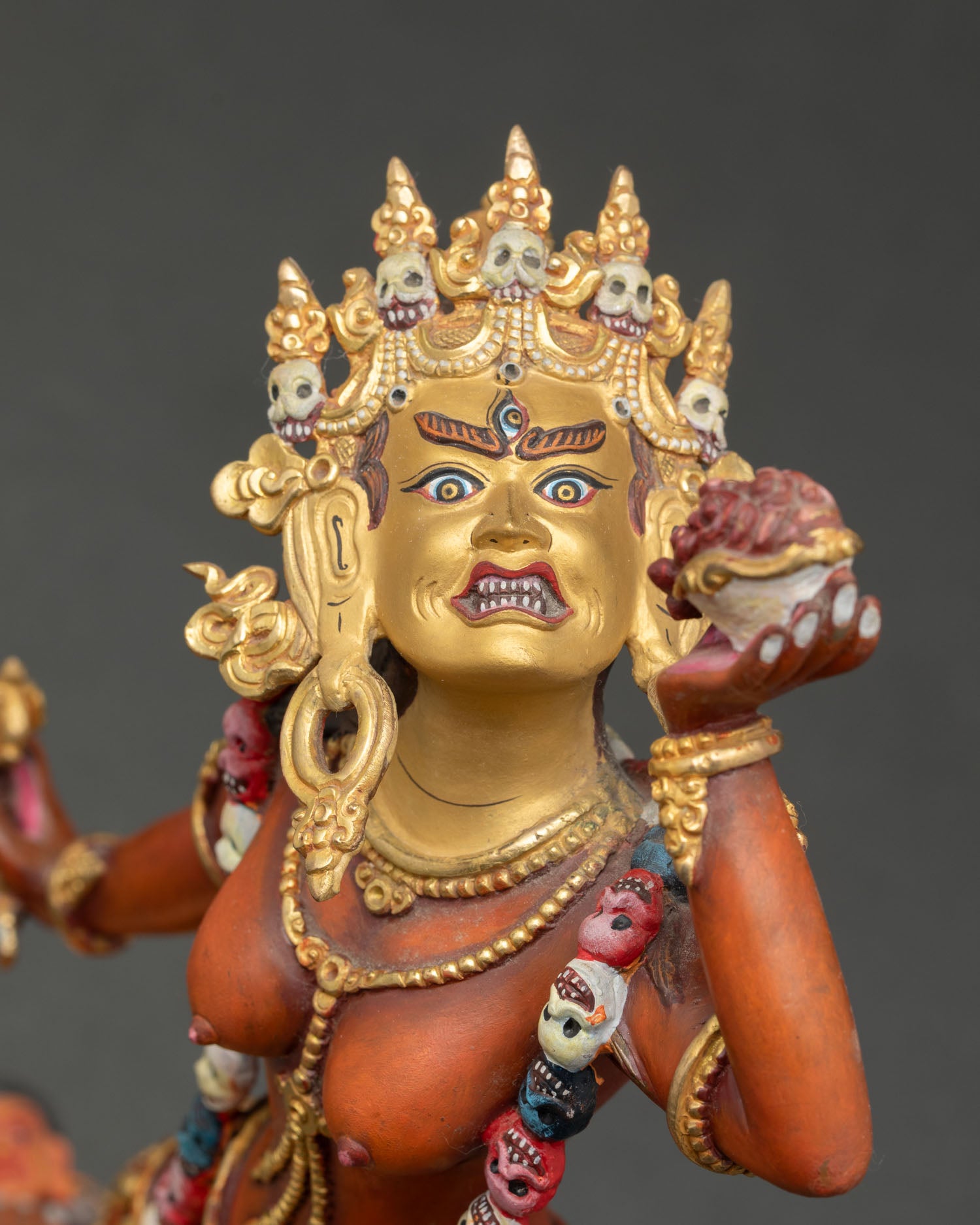 Close up Vajrayogini face gold painted details Newari artisan wrathful goddess statue for Vajrayana wisdom protection practice