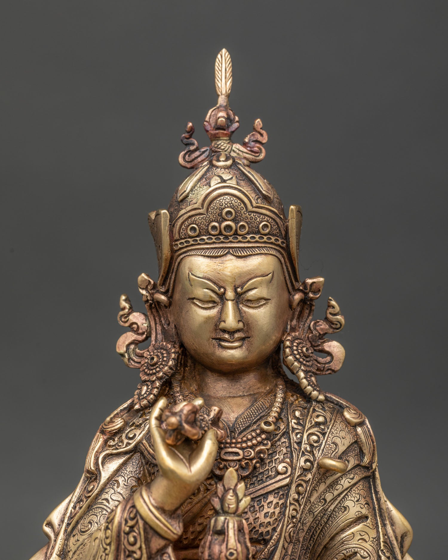 Close-up view of copper Tsokye Dorje statue showcasing intricate Himalayan craftsmanship