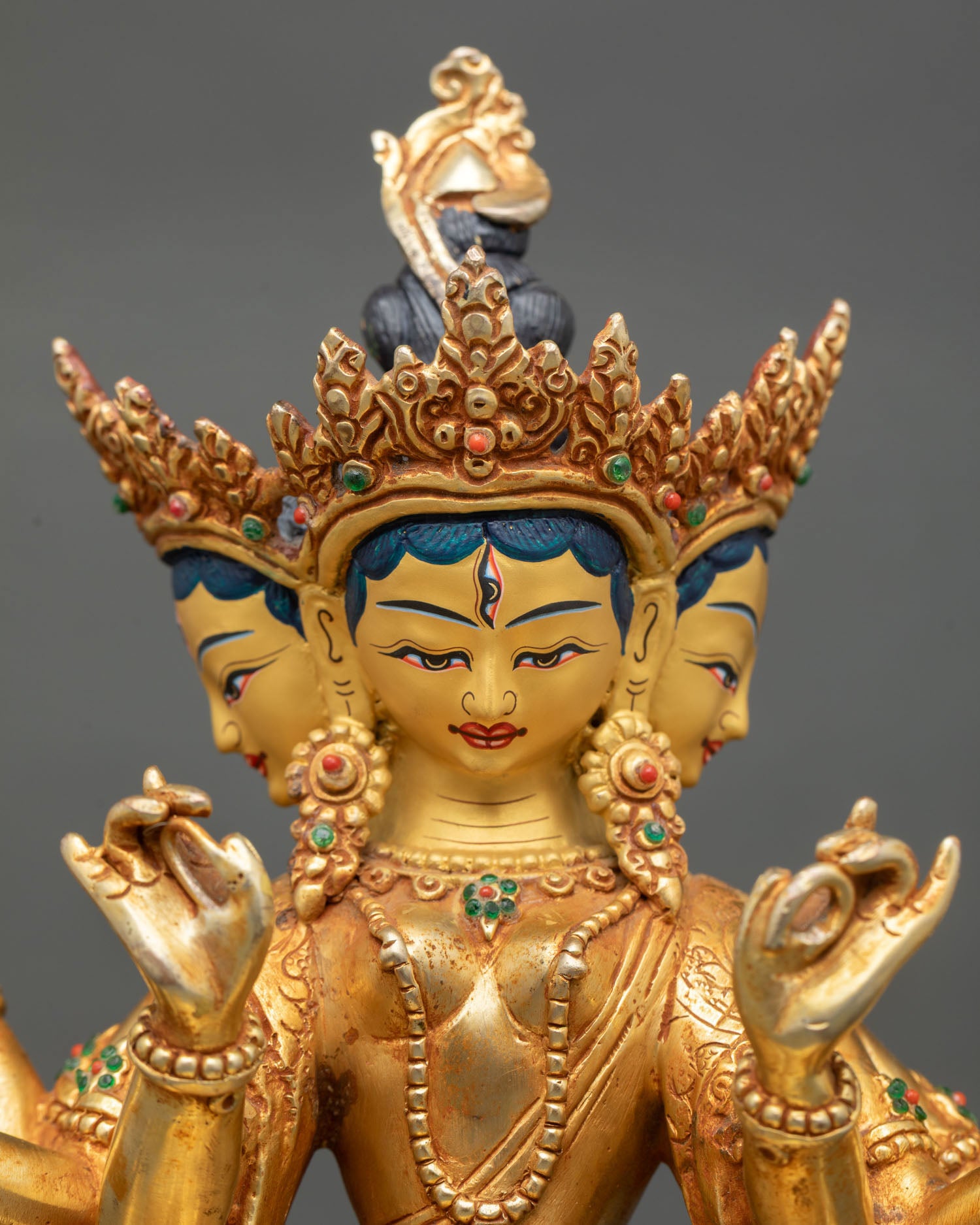 Close up view of Dhoja Devi statue gold painted face with intricate Newari craftsmanship detailed ornamentation and sacred Vajrayana Buddhist art expression
