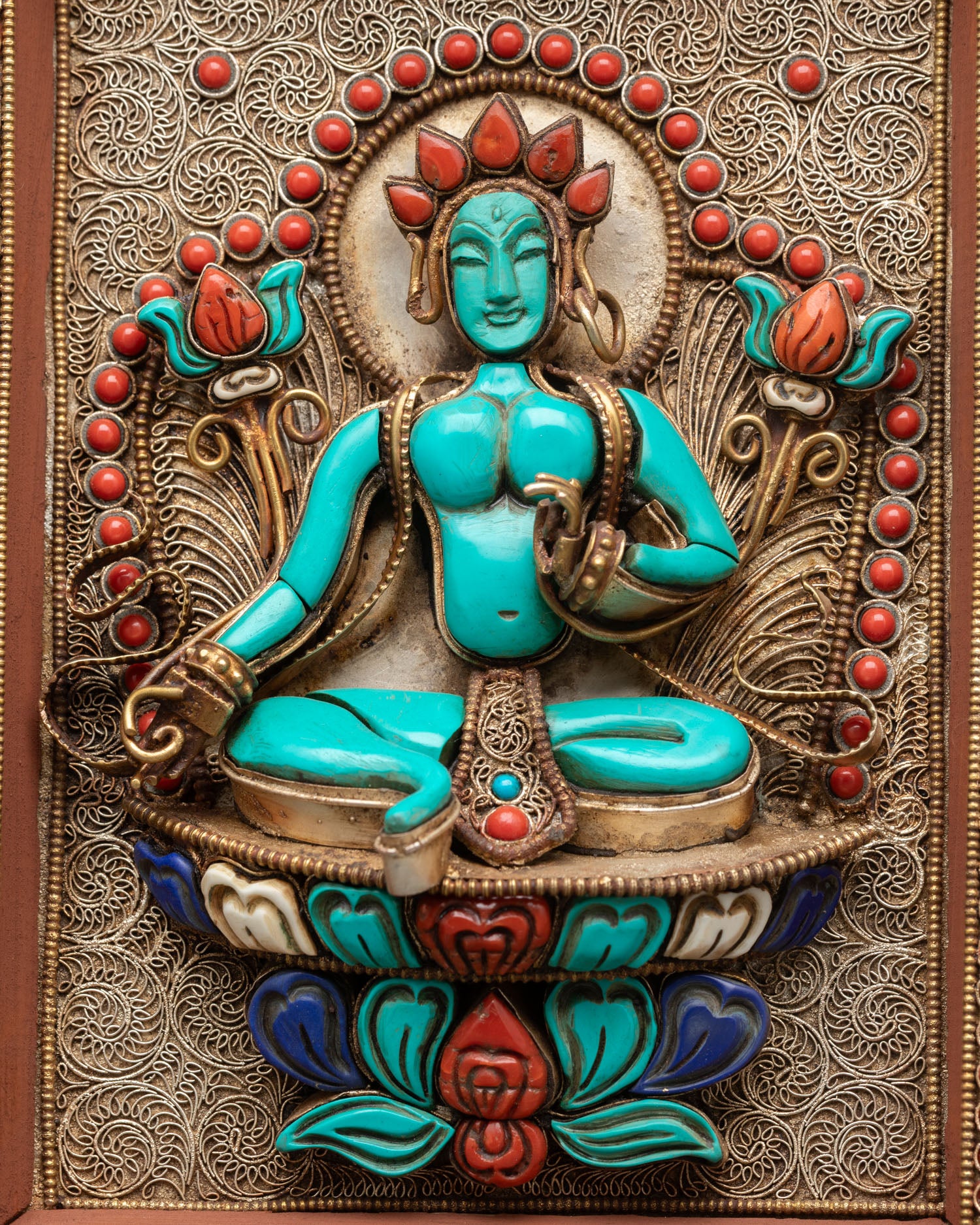 Close up view of Green Tara central figure in mandala wall hanging symbolizing compassion protection and calm spiritual energy with gold plated detailing