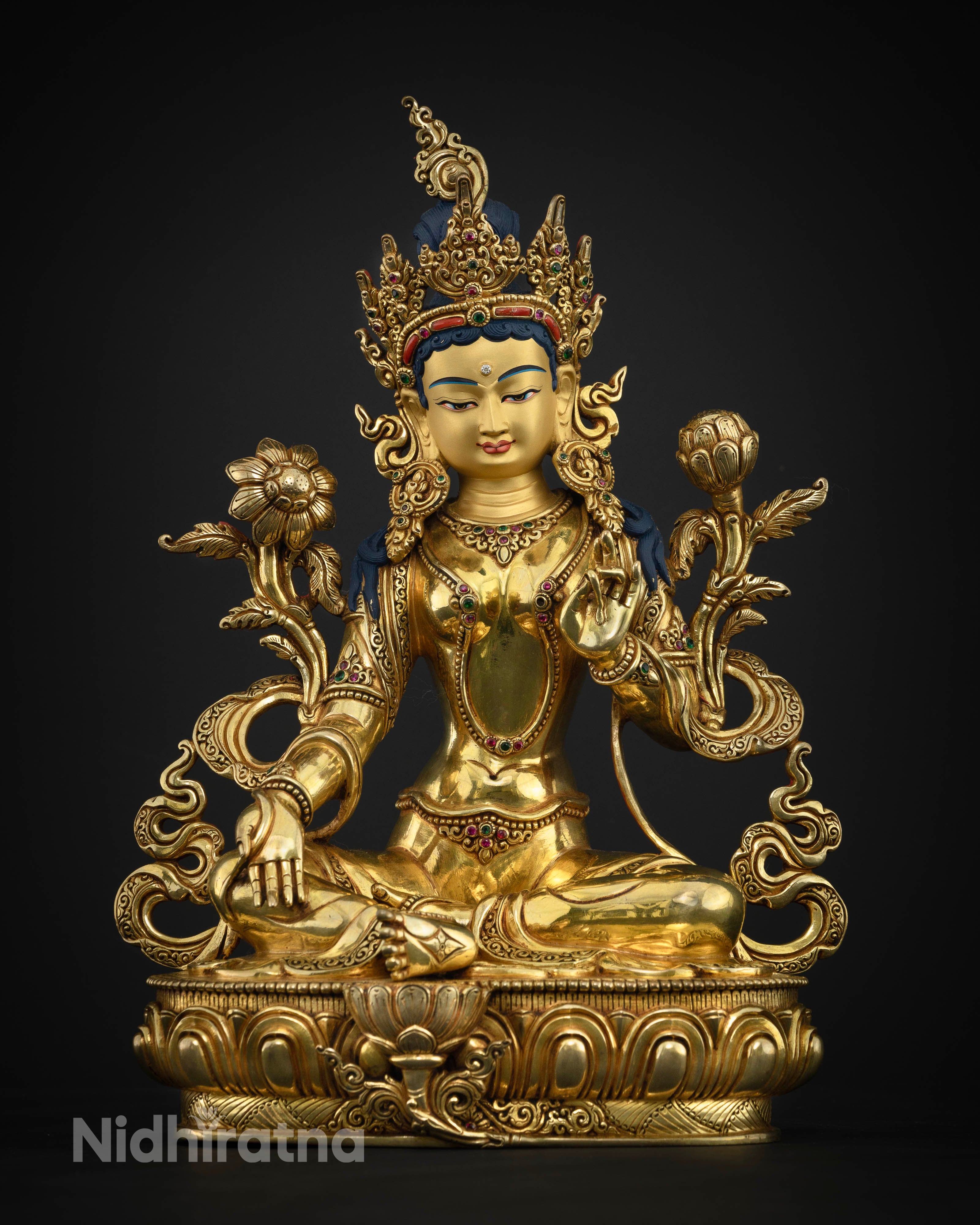 Close Up View of Green Tara statue face with serene expression and sacred details