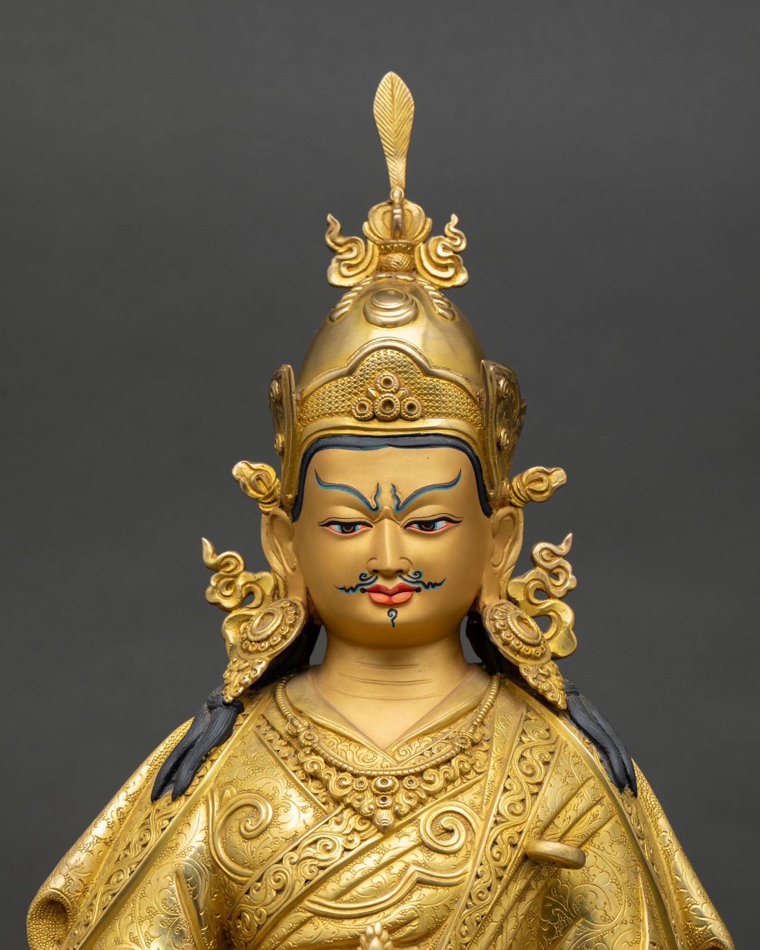 Close-up view of Guru Rinpoche with a finely detailed gold-painted face, reflecting Himalayan Newari craftsmanship from Patan, Nepal.