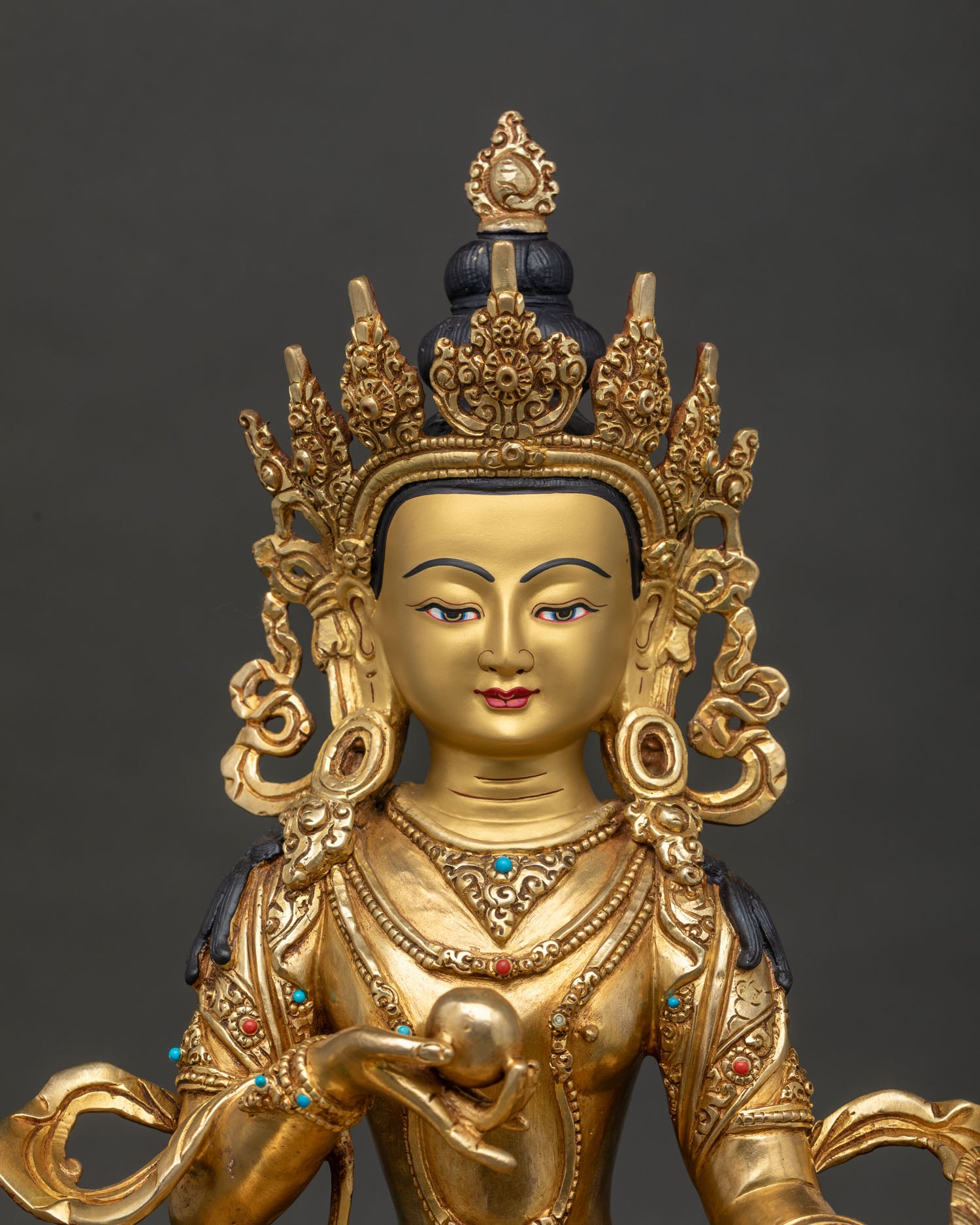 Close Up View of Kshitigarbha Statue with Gold Painted Face and Semi Precious Stones