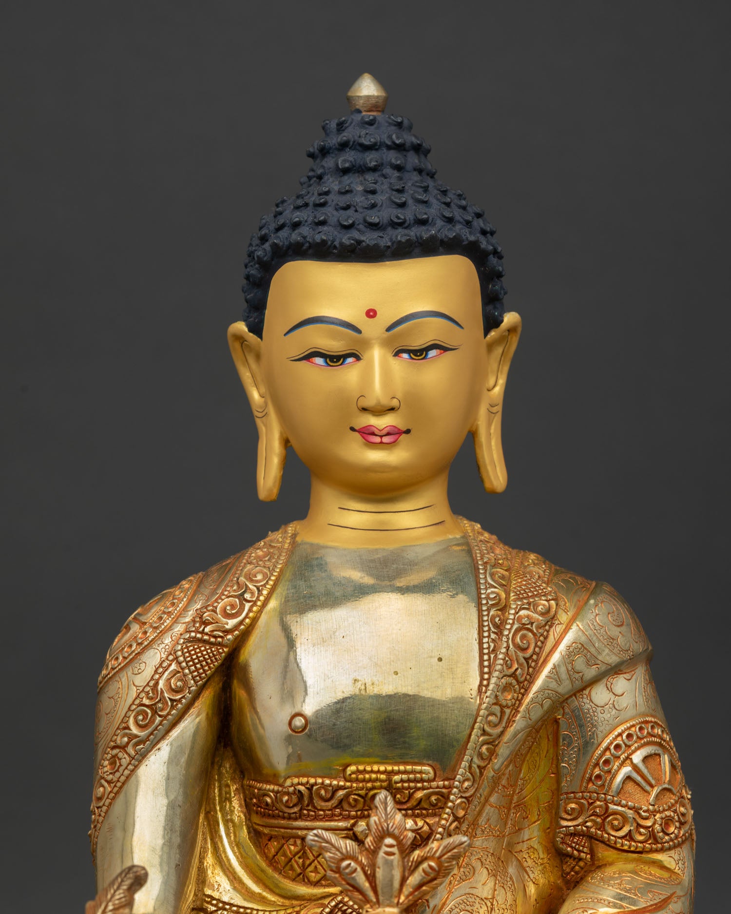 Close Up View of Medicine Buddha Statue with Gold Painted Face