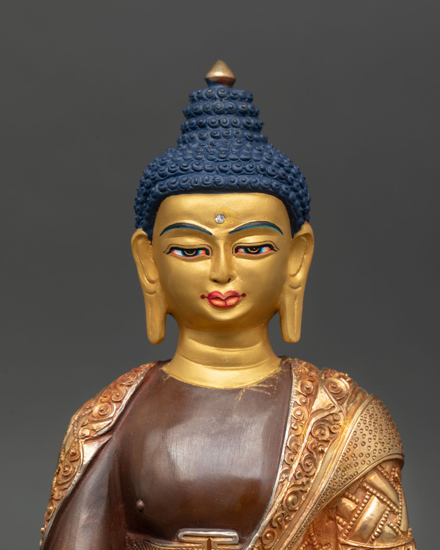 Close up view of Shakyamuni Buddha serene golden face with calm expression, detailed craftsmanship in copper alloy
