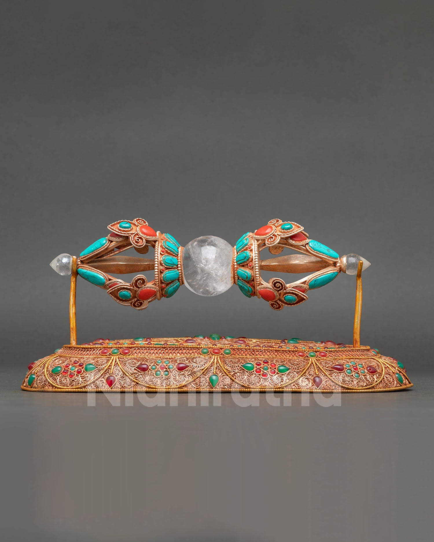 close up view of vajra dorje with crystal core copper body and turquoise coral inlay detail