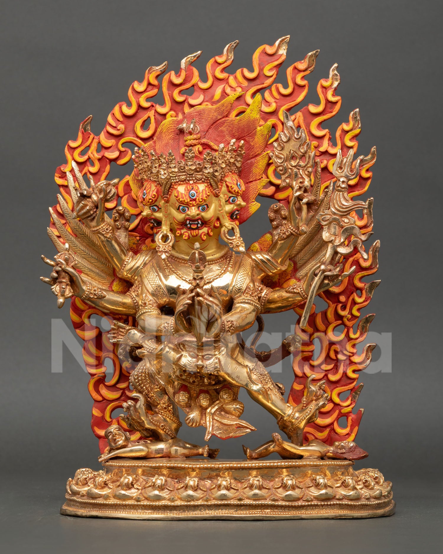 Close up view of Vajrakilaya statue showing detailed gold painted wrathful face and ritual attributes symbolizing purification and protection