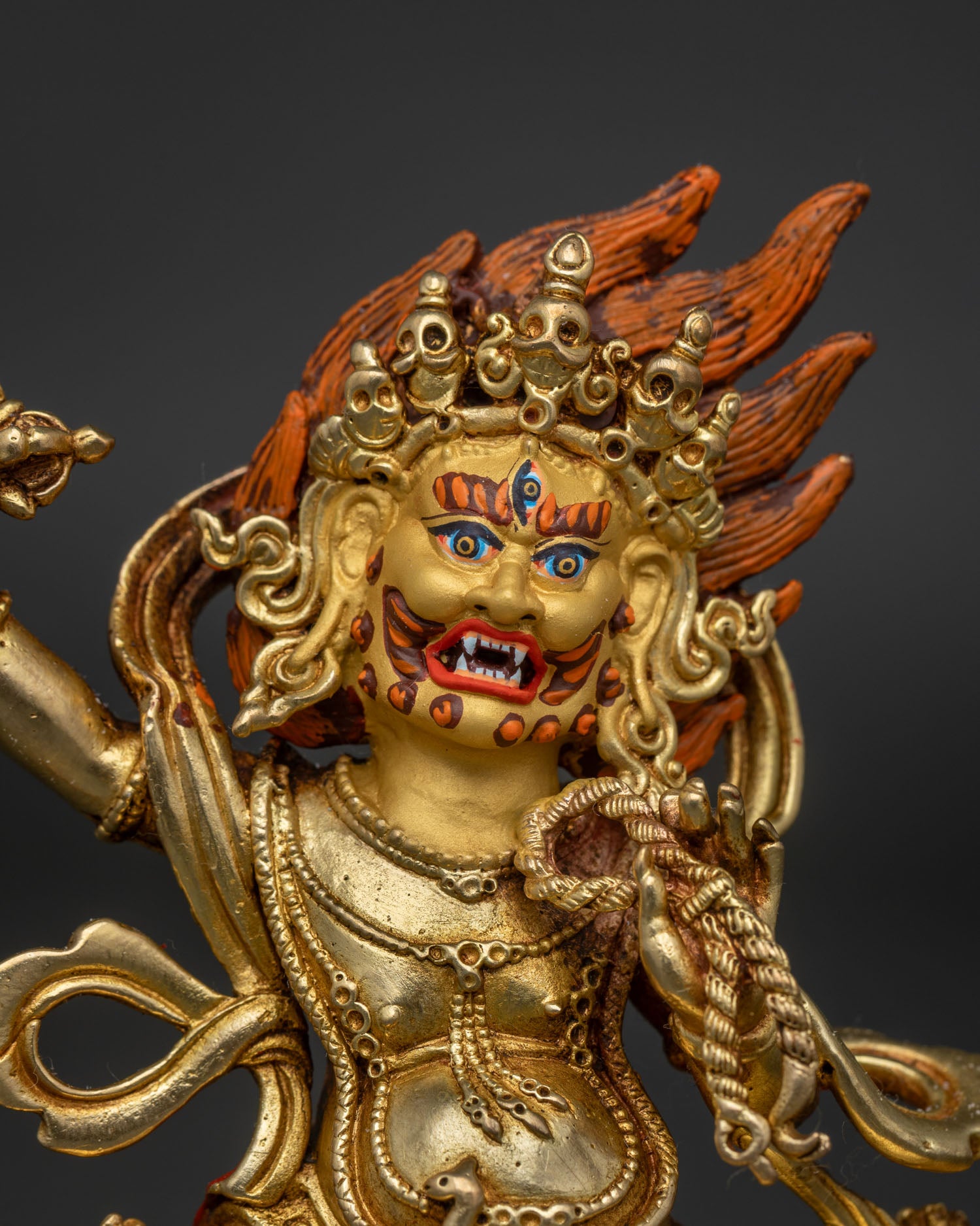 Close up view of Vajrapani Buddhist deity holding vajra and lasso