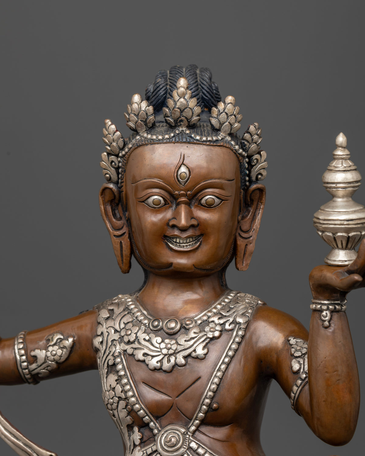 Close up of Virupaksha statue holding kapala skull cup and sacred vase