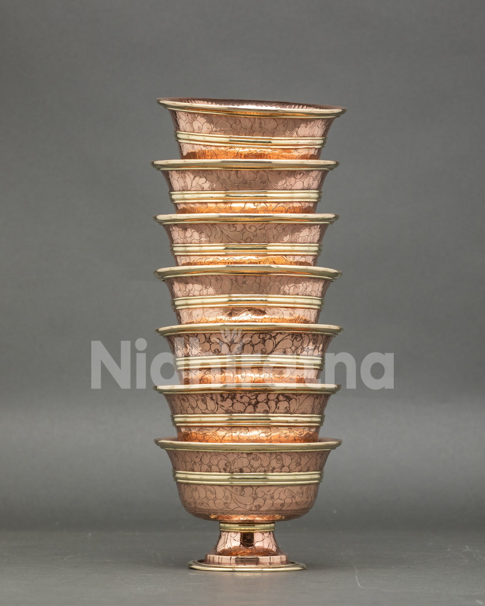 Close-up water offering bowl, copper, handcrafted Tibetan ritual set