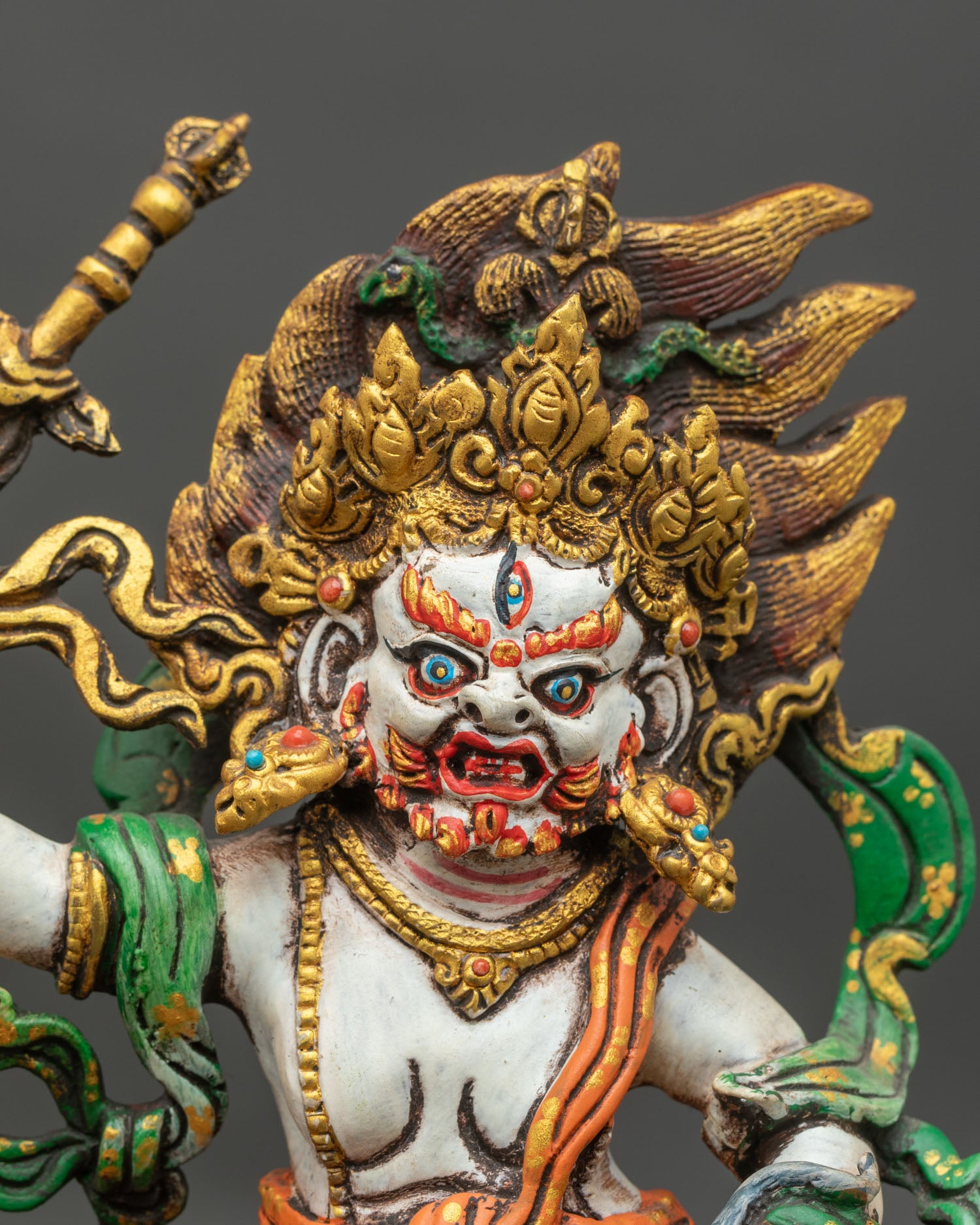 Close-up of White Dzambhala statue showing intricate copper and acrylic painting