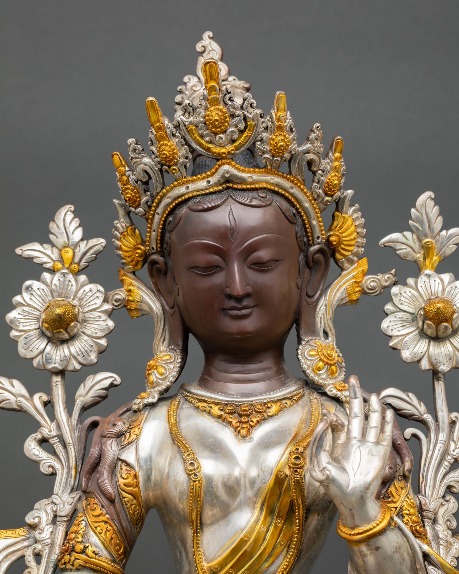 Close up White Tara face gold accents seven eyes compassionate expression