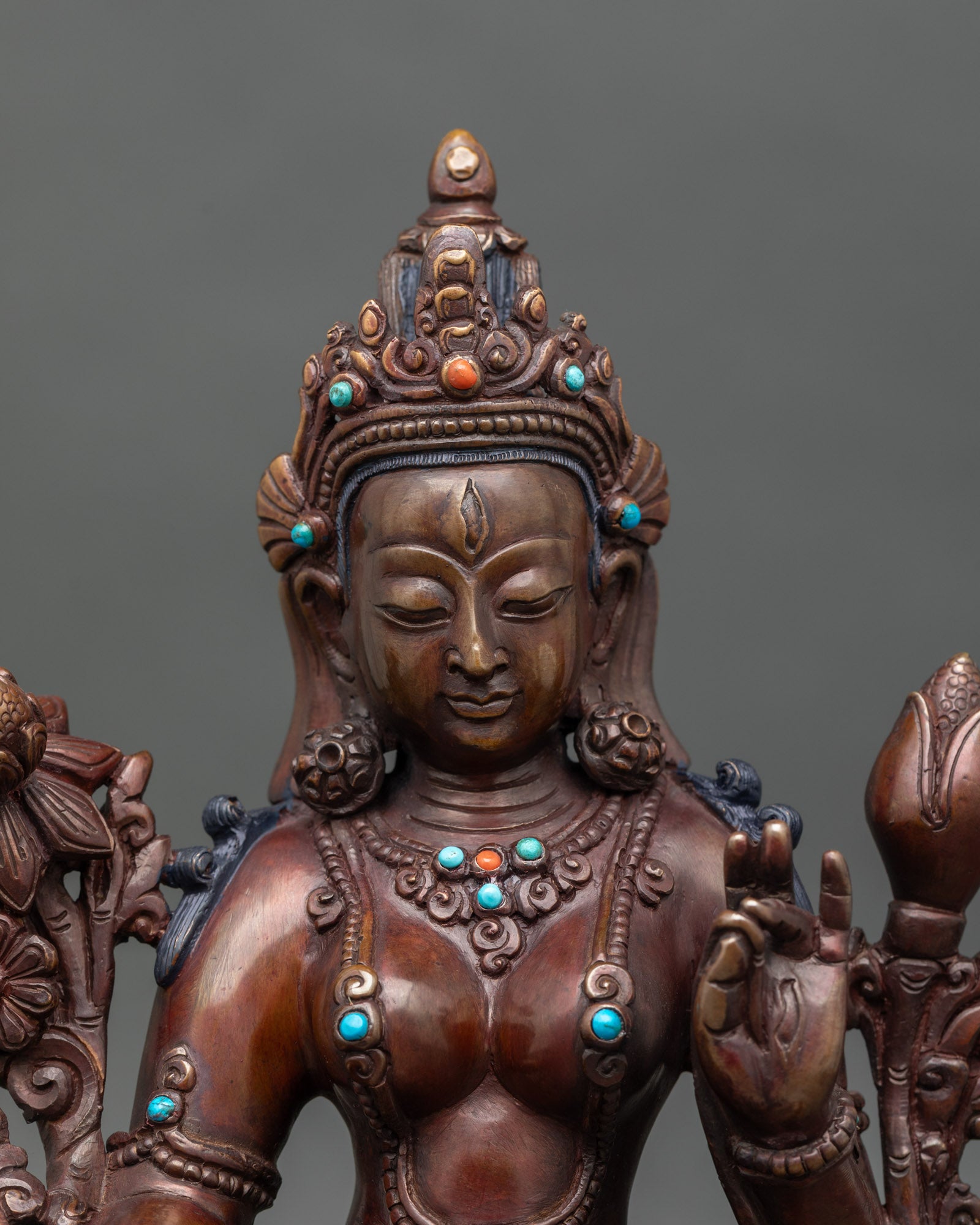 Close up White Tara face serene goddess lotus throne turquoise coral Himalayan sculpture