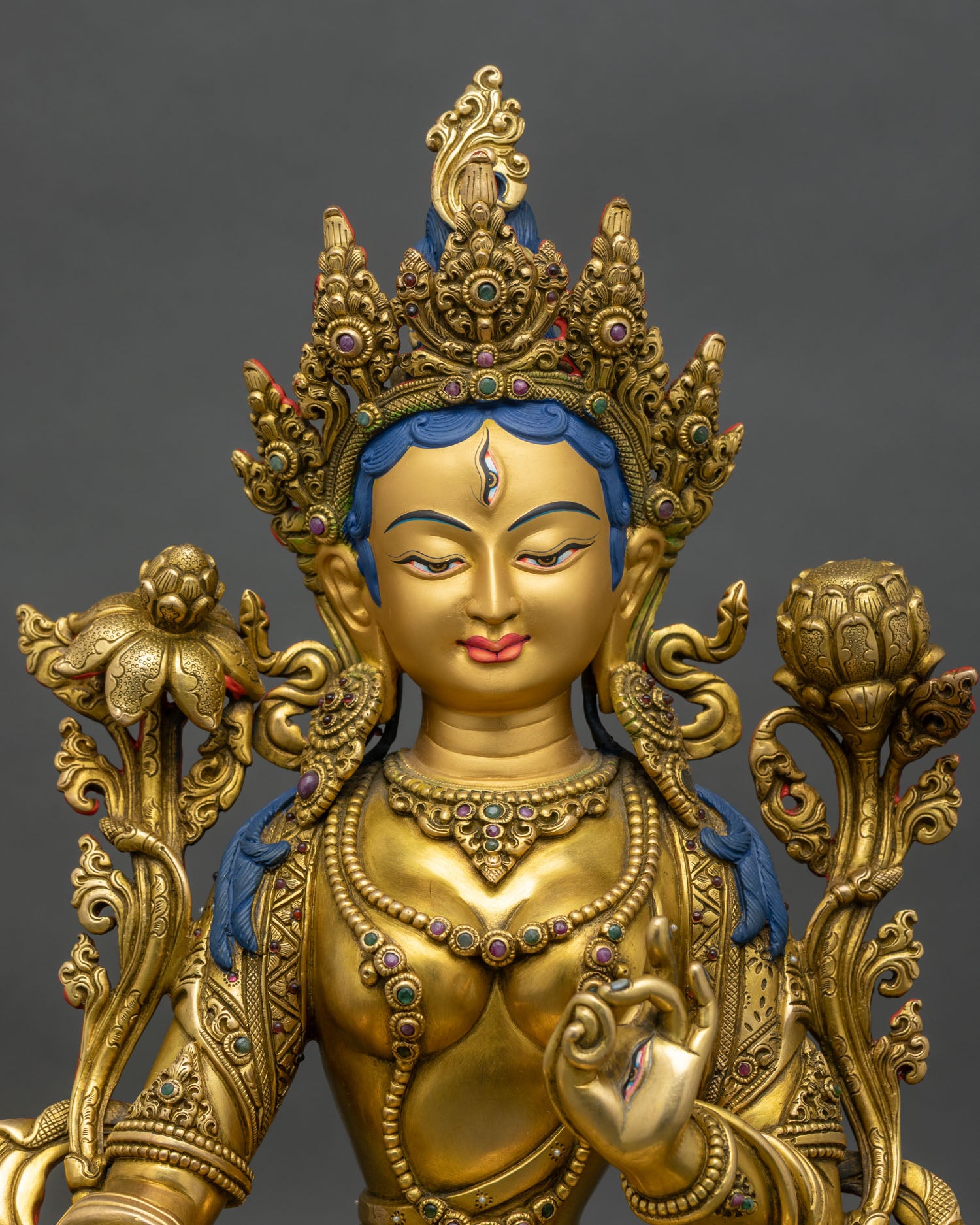 Close-up of White Tara statue, detailed copper and gold craftsmanship