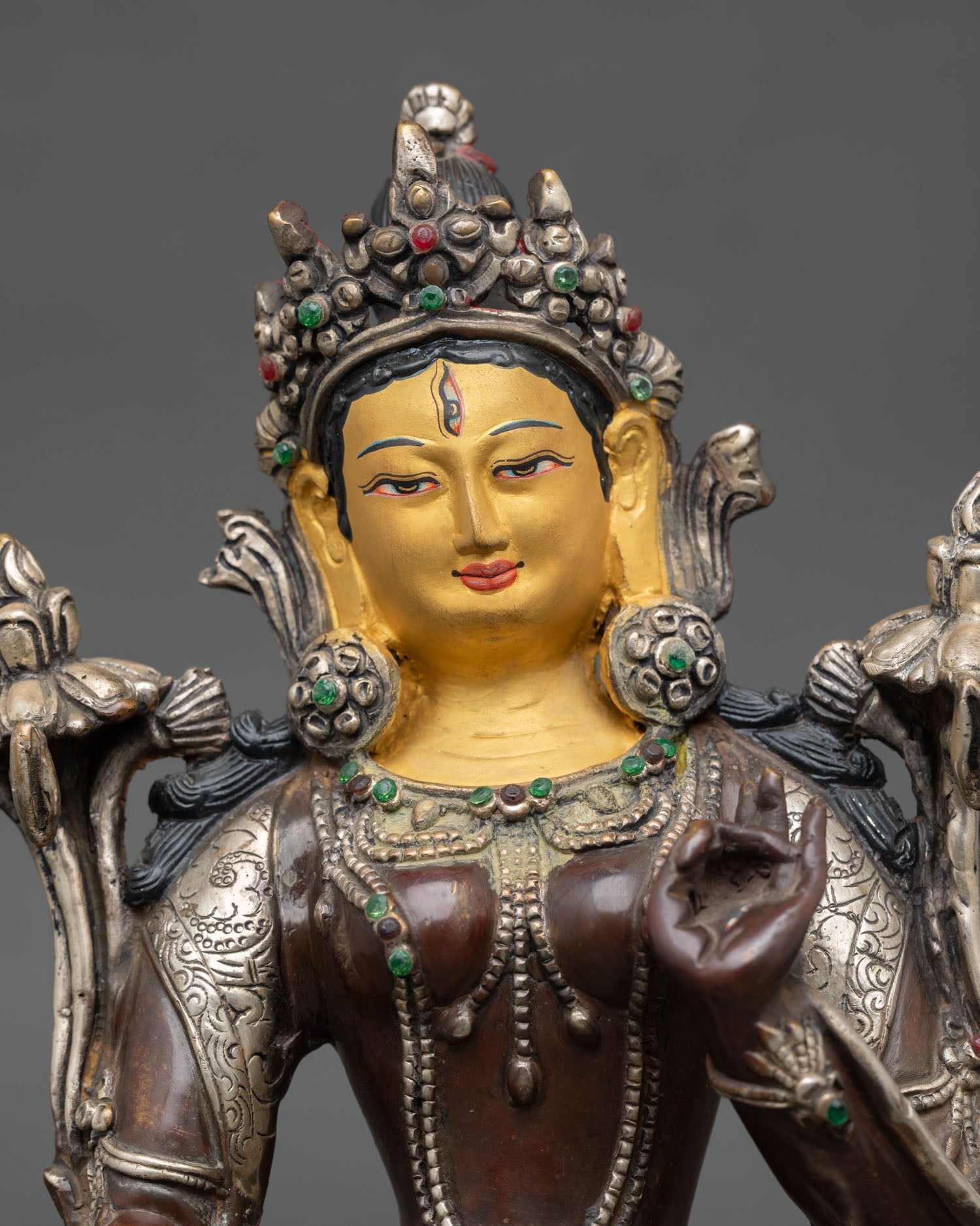 Close up White Tara statue serene expression seven eyes symbolism intricate Himalayan craftsmanship oxidized copper details