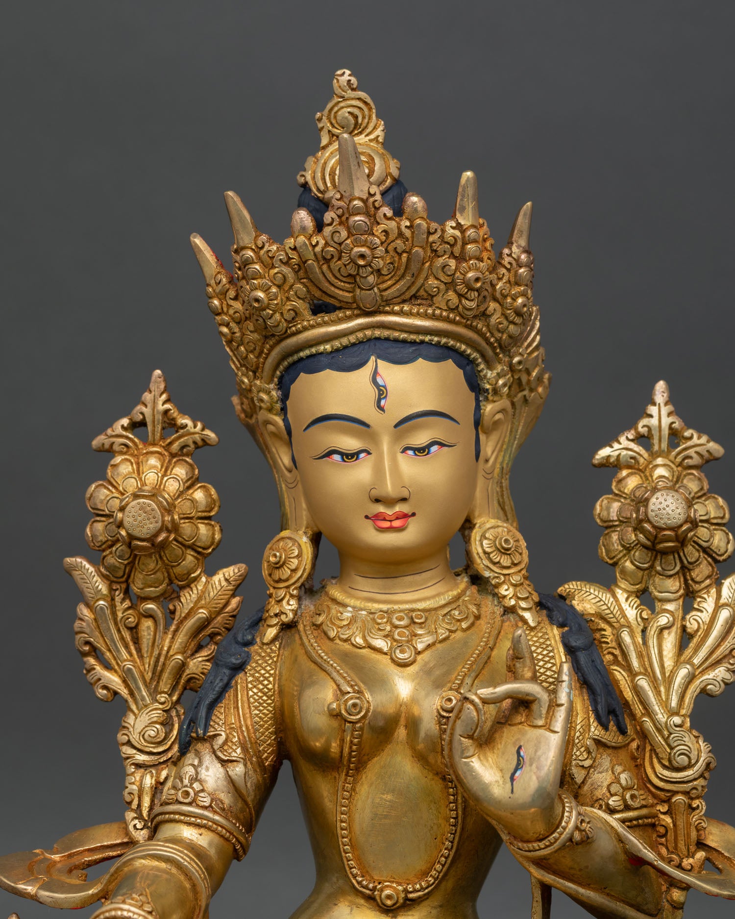 Close up White Tara Statue showing seven eyes compassion healing goddess with blue lotus abhaya mudra and varada mudra details