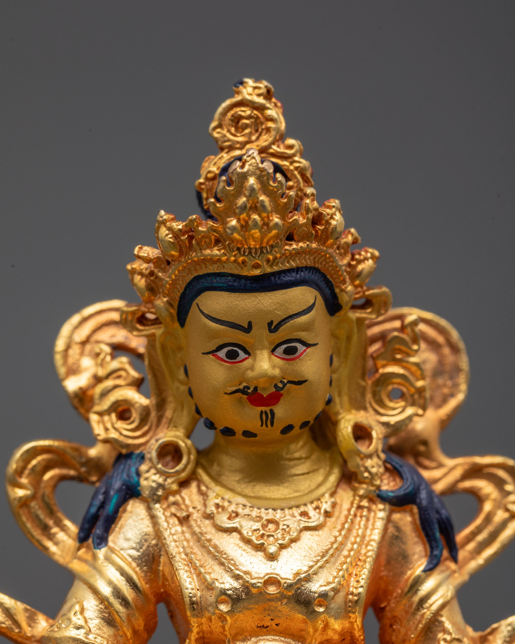 close-up of crown and jewelry on precision-crafted Jambhala deity statue