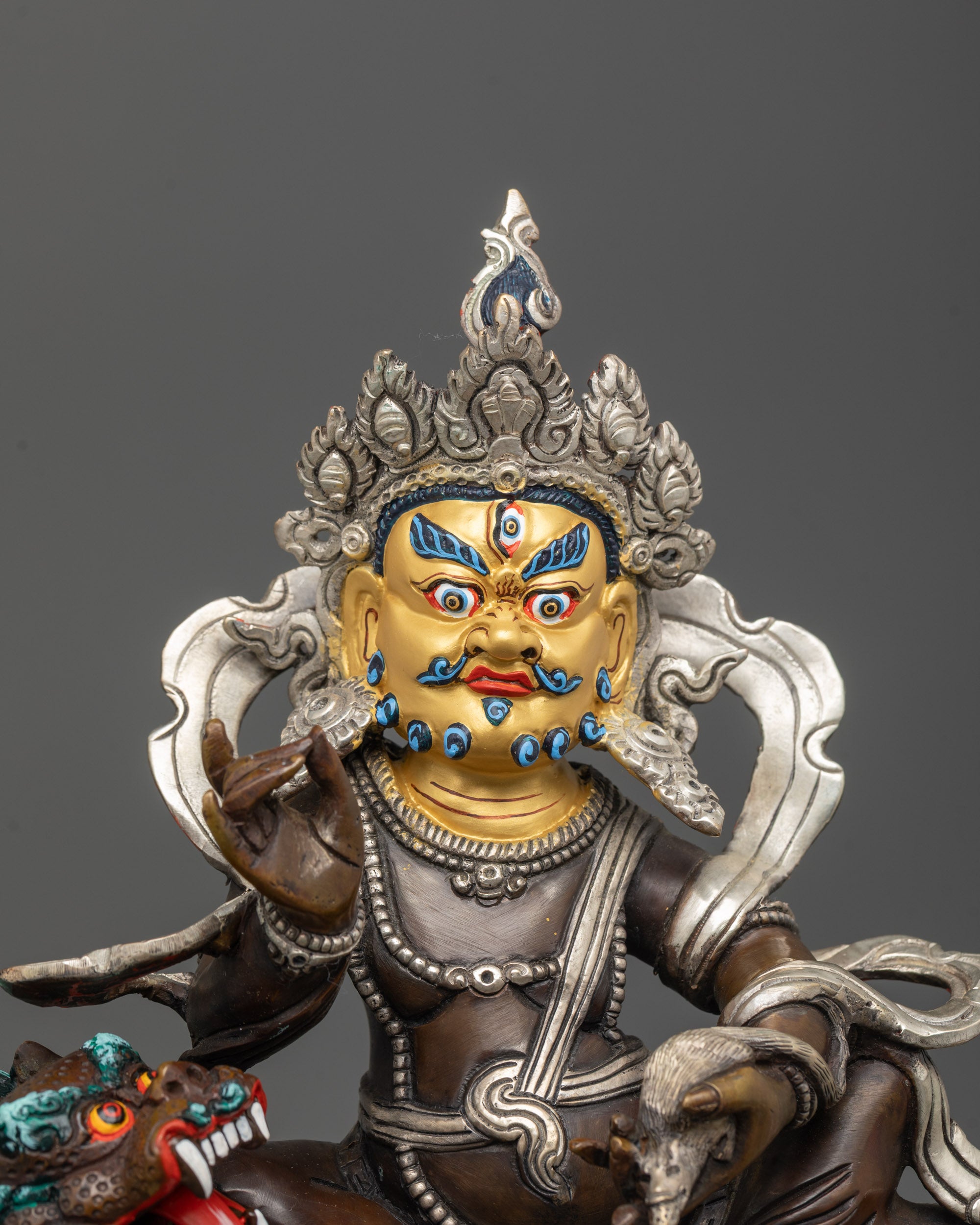 close-up of namtoshe statue showing oxidized copper body and silver-plated fearful halo