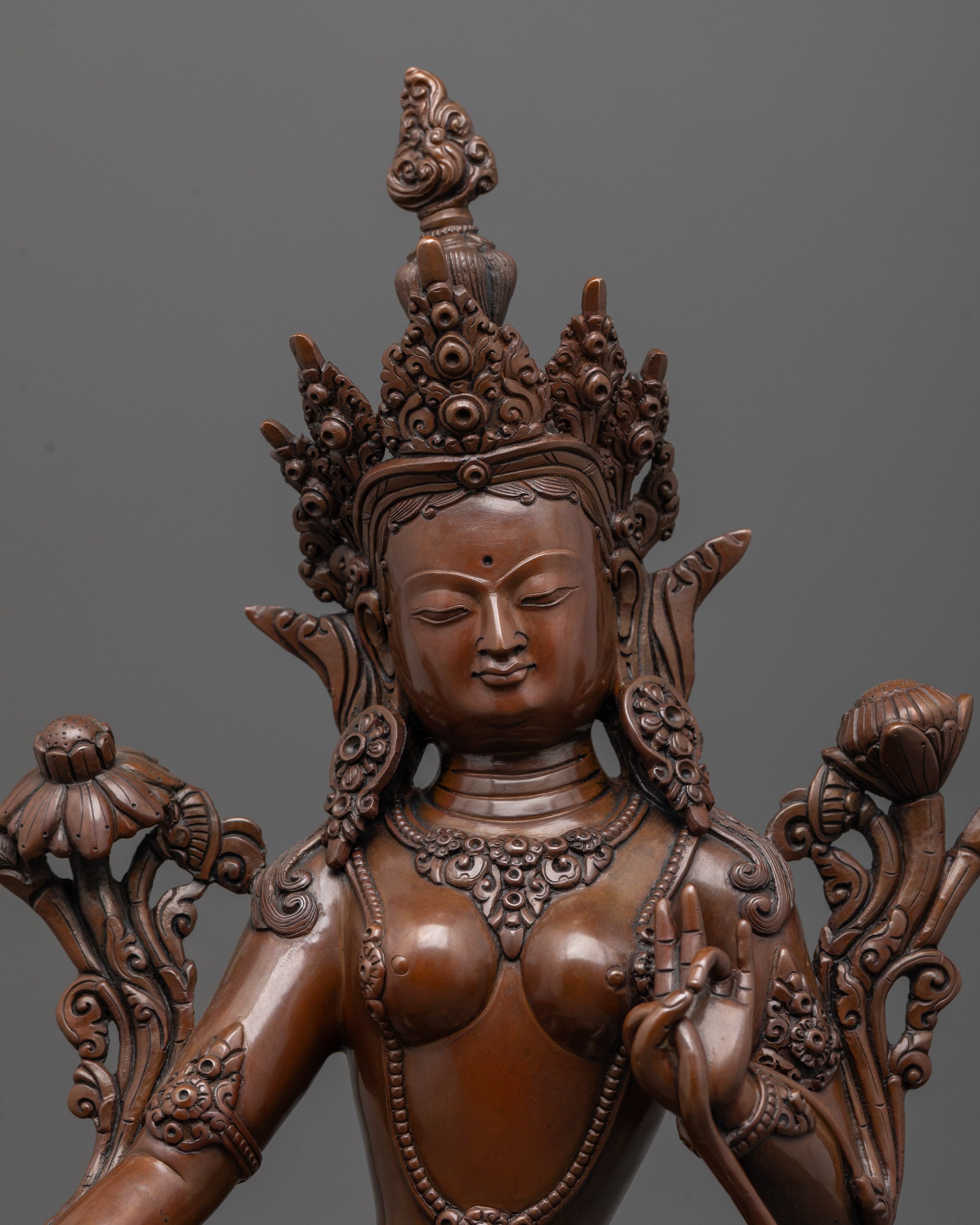 close-up of oxidized green tara face showing lost wax casting and artisan craftsmanship