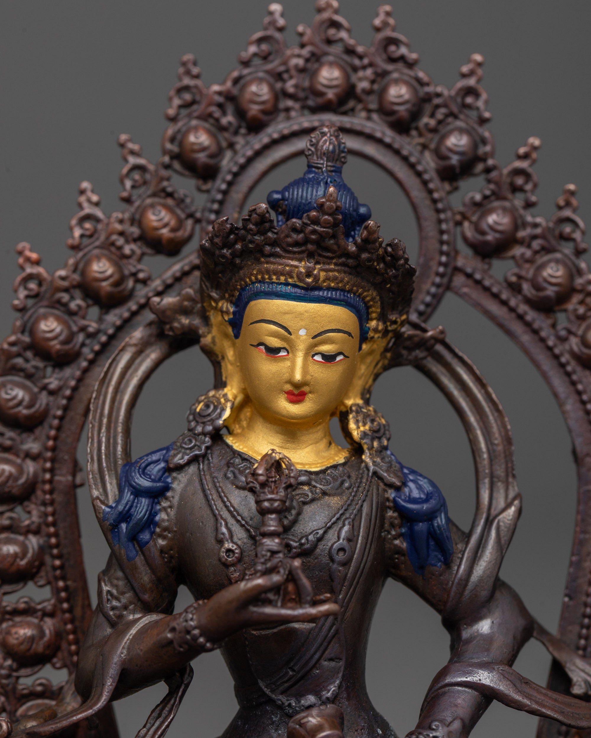 close-up of vajrasattva statue showing jeweled robes and finely detailed lotus seat