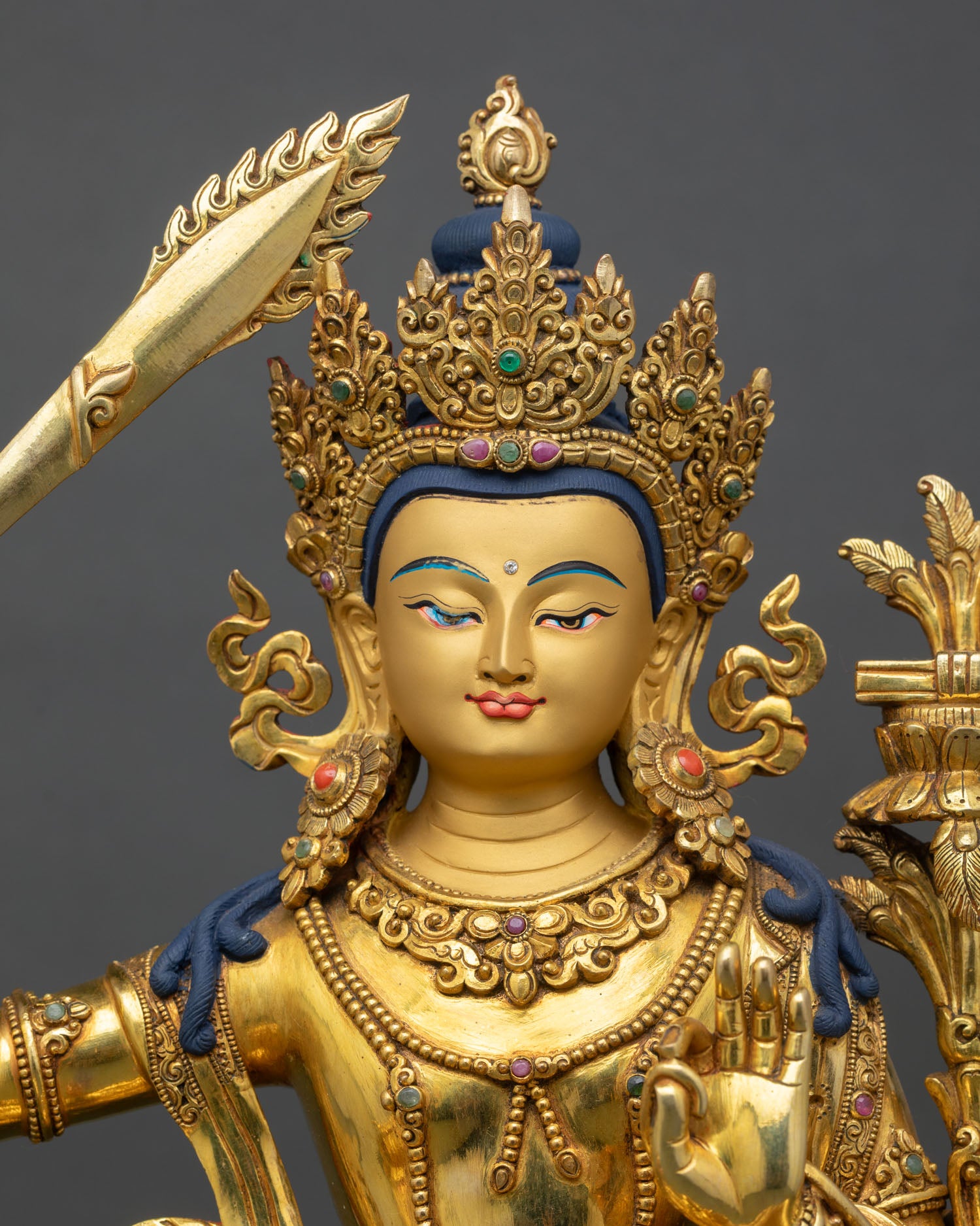close view of simhanada manjushri statue, intricate copper craftsmanship and sacred ornaments