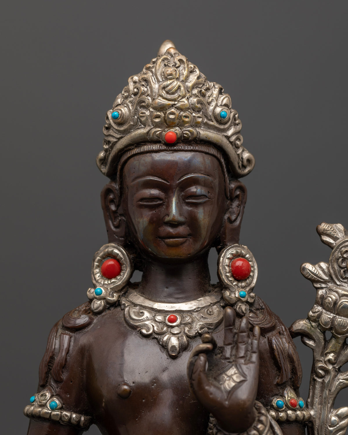 Close view of Padmapani face crown and semi precious stone ornaments.