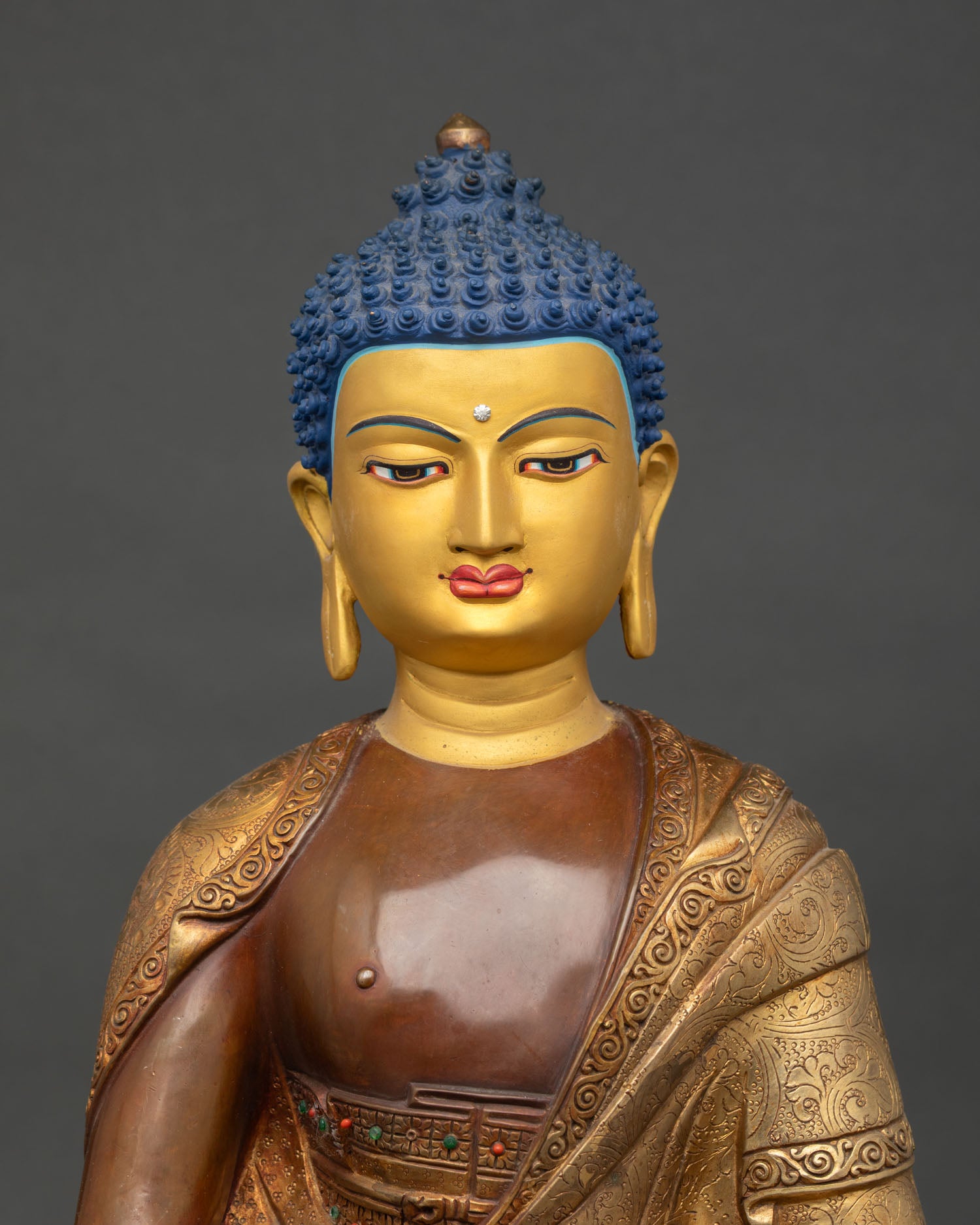 Close view serene gold painted face Amitabha Buddha copper statue with halo detail and calm expression