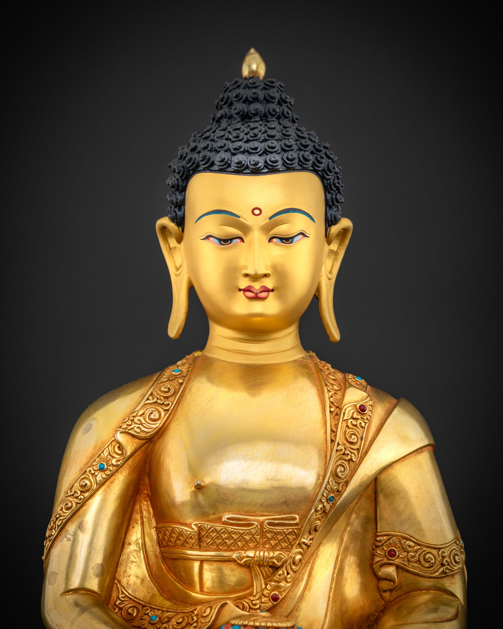 close up Amitabha Buddha statue fine detailing gold-painted face Nepalese artisan craftsmanship