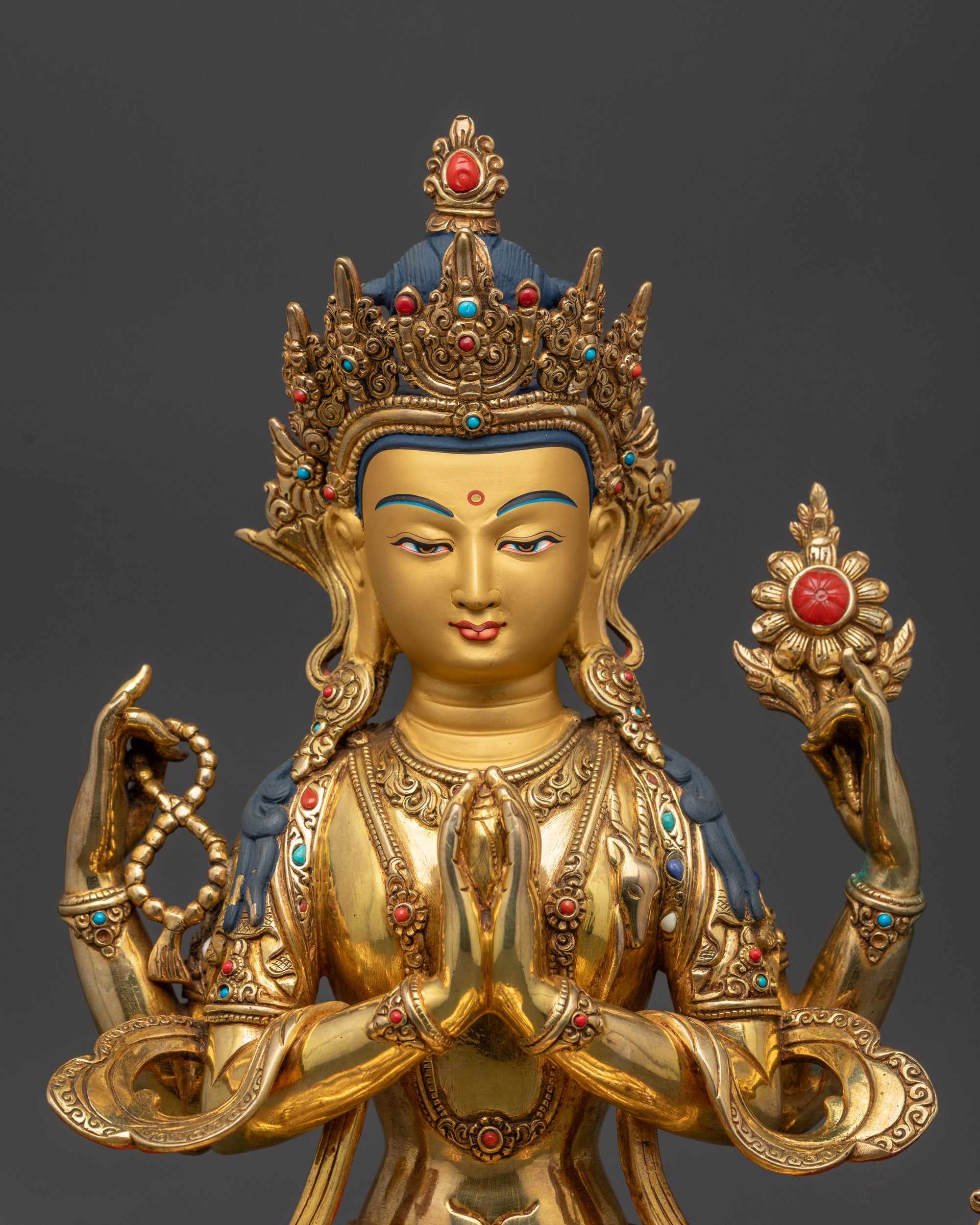 close up Chenrezig showing jeweled crown, crystal mala, lotus flower, and serene face