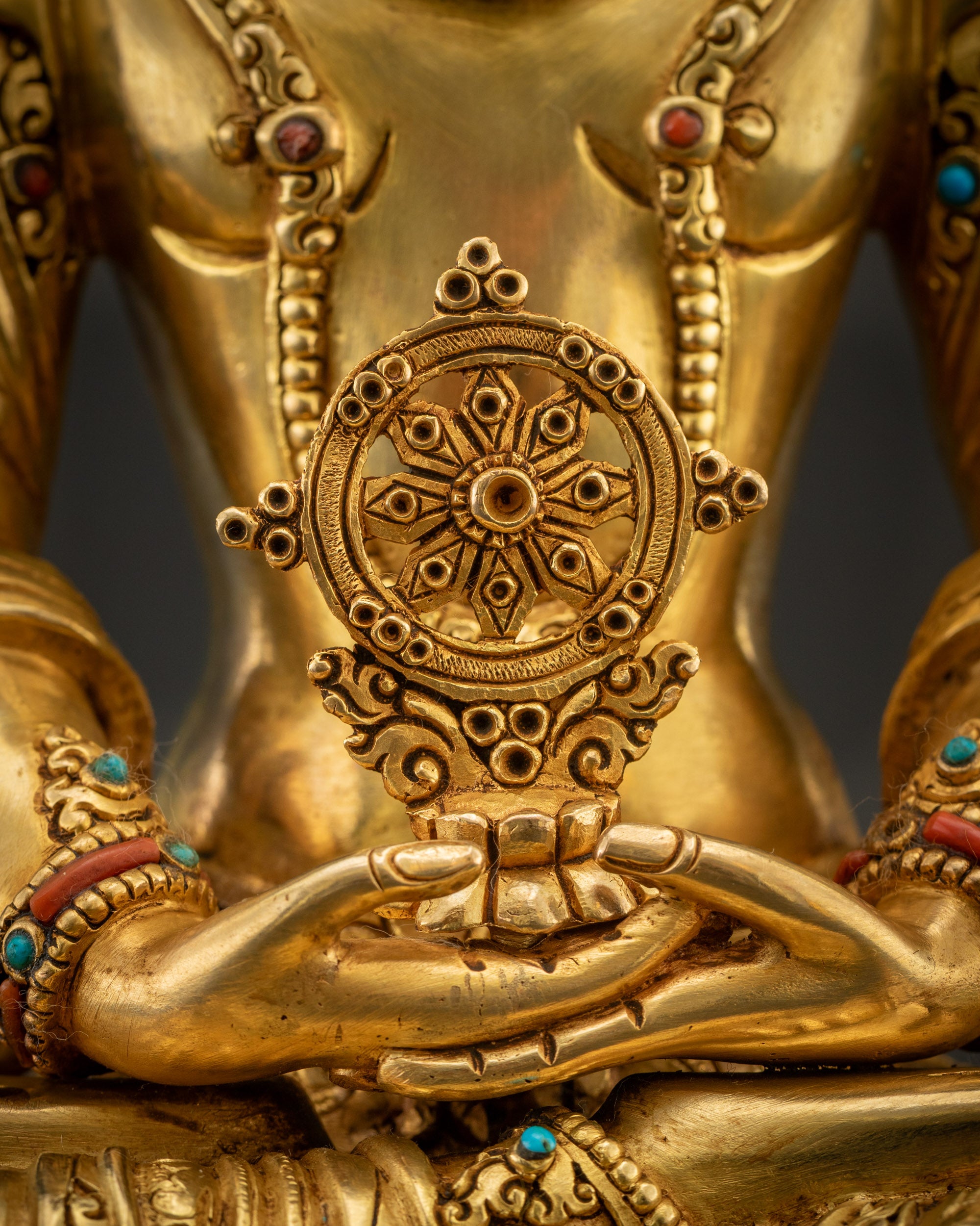 close up Dharmachakra Dharma Wheel in Dhyana mudra held by Vairocana Buddha statue for altar