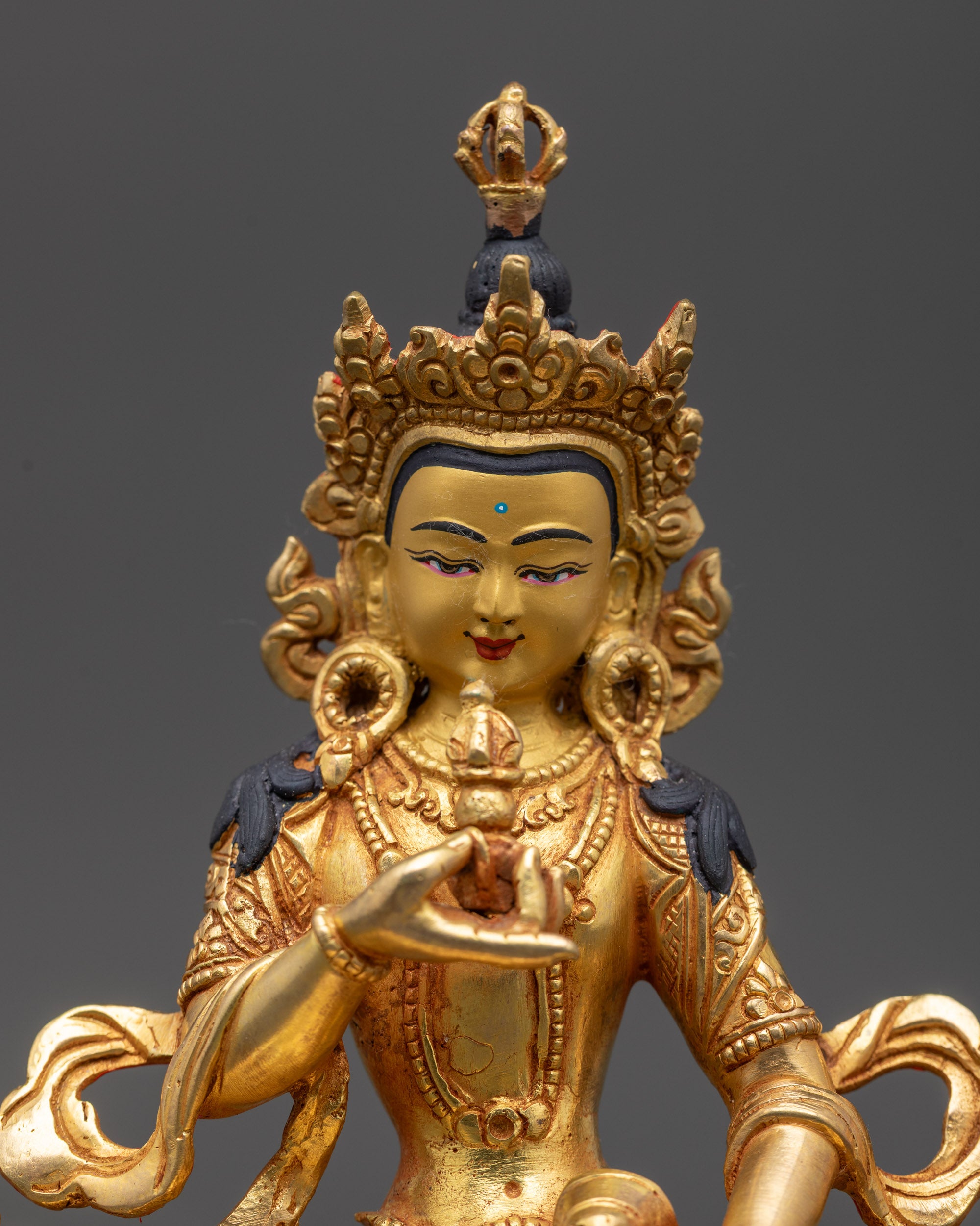close up Dorje Sempa Vajrasattva idol showing serene face and ornate crown