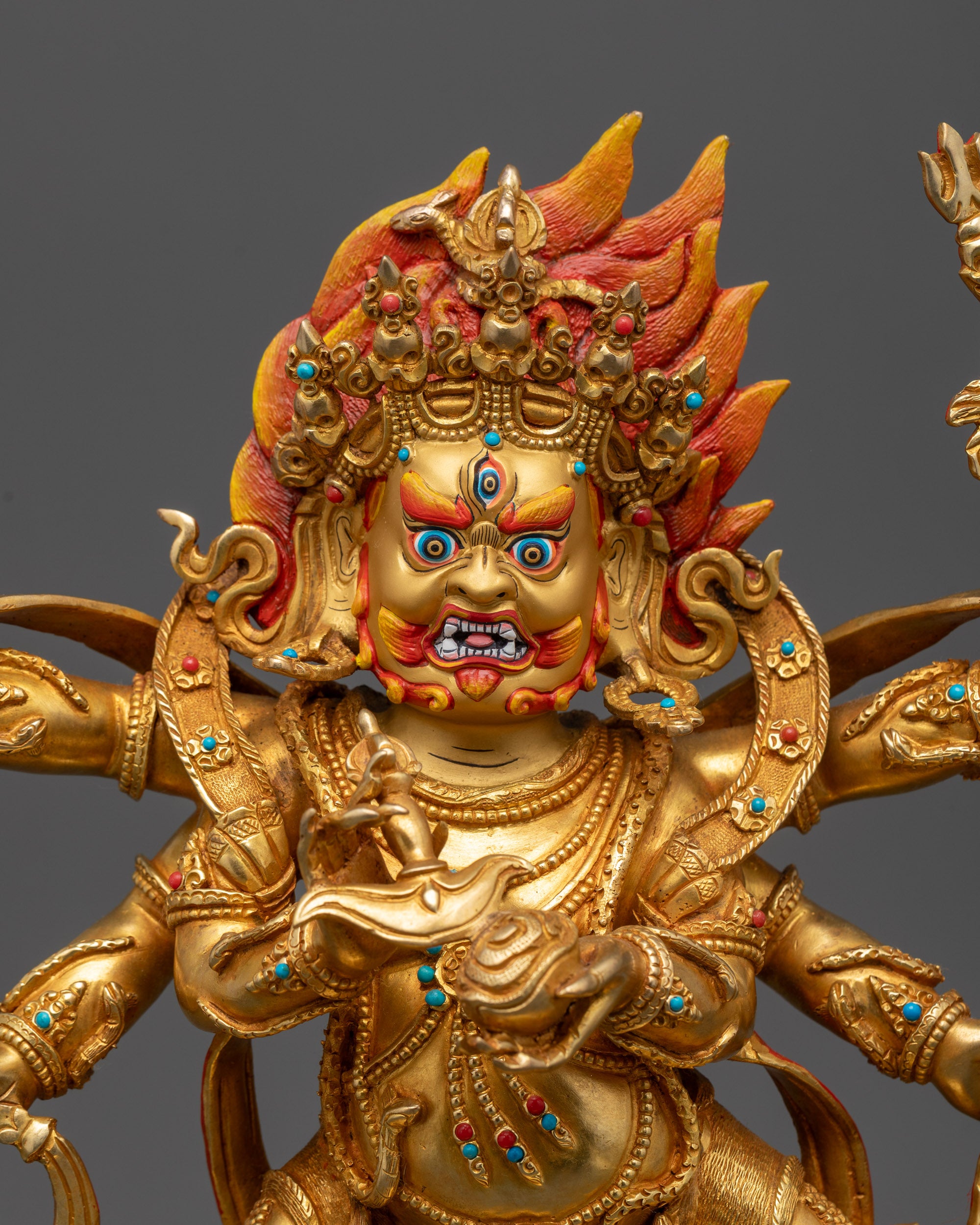 close up Mahakala Statue showing wrathful expression and flaming red hair