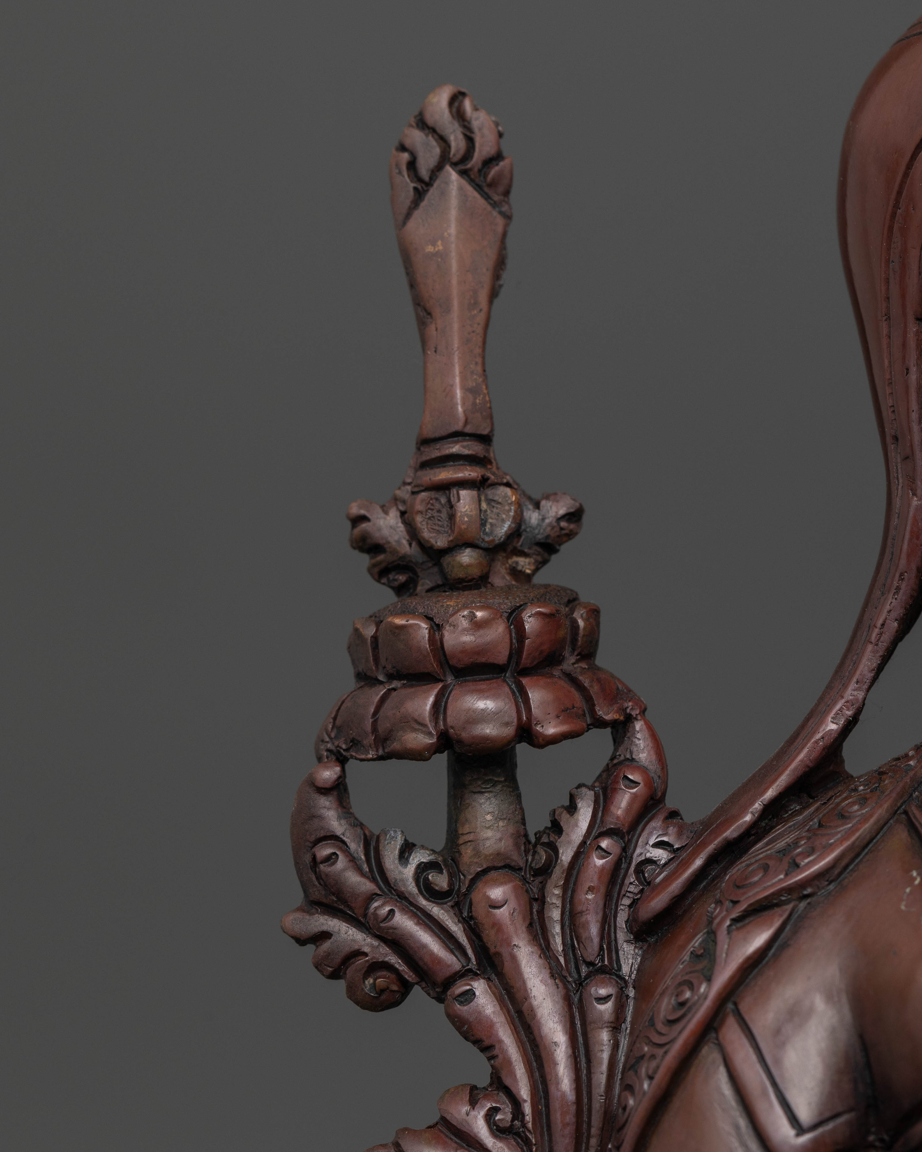 close up Oxidized Tsongkhapa statue detailed craftsmanship highlighting wisdom and compassion