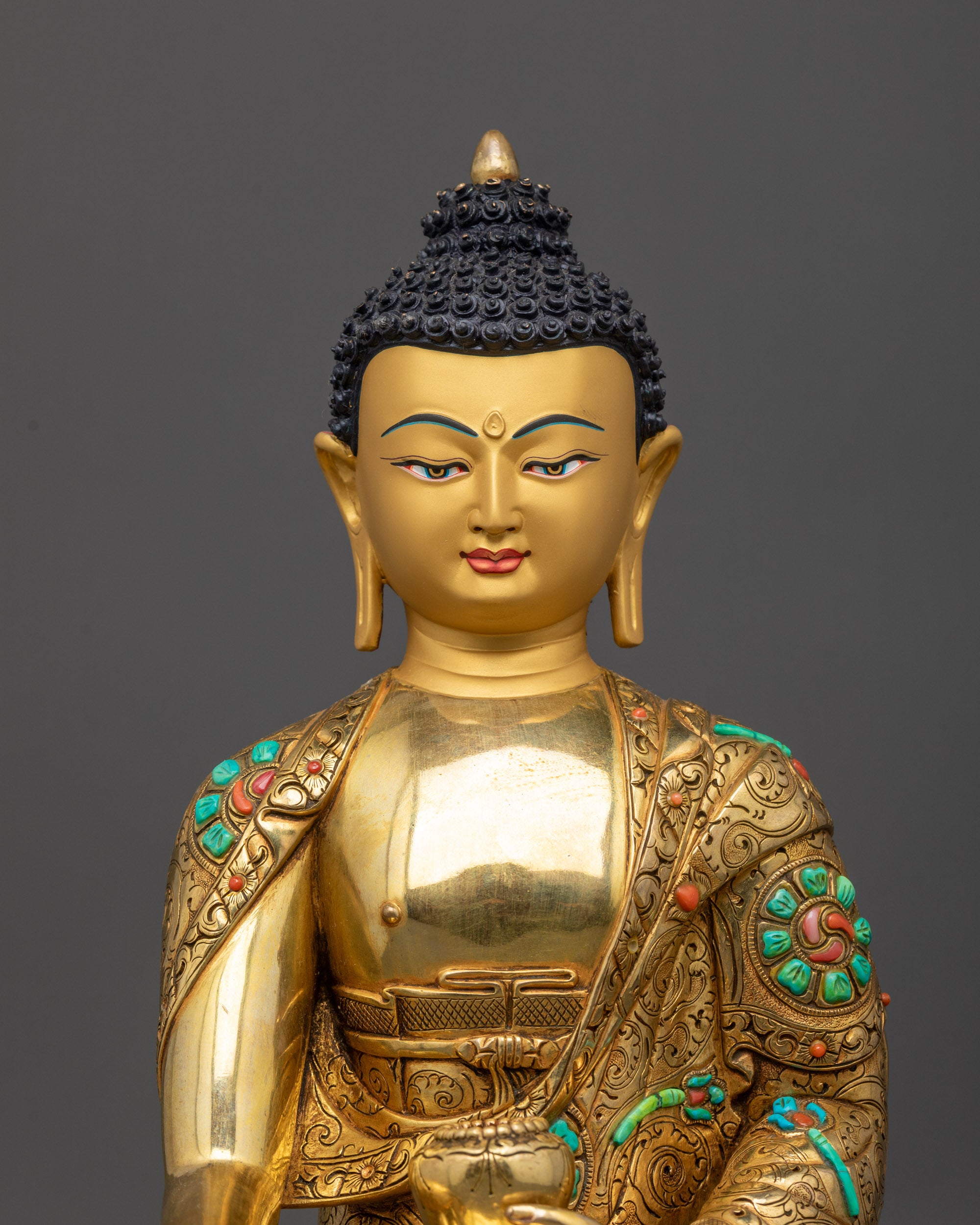 close up Shakyamuni Buddha face and patra bowl details lost-wax carved patterns