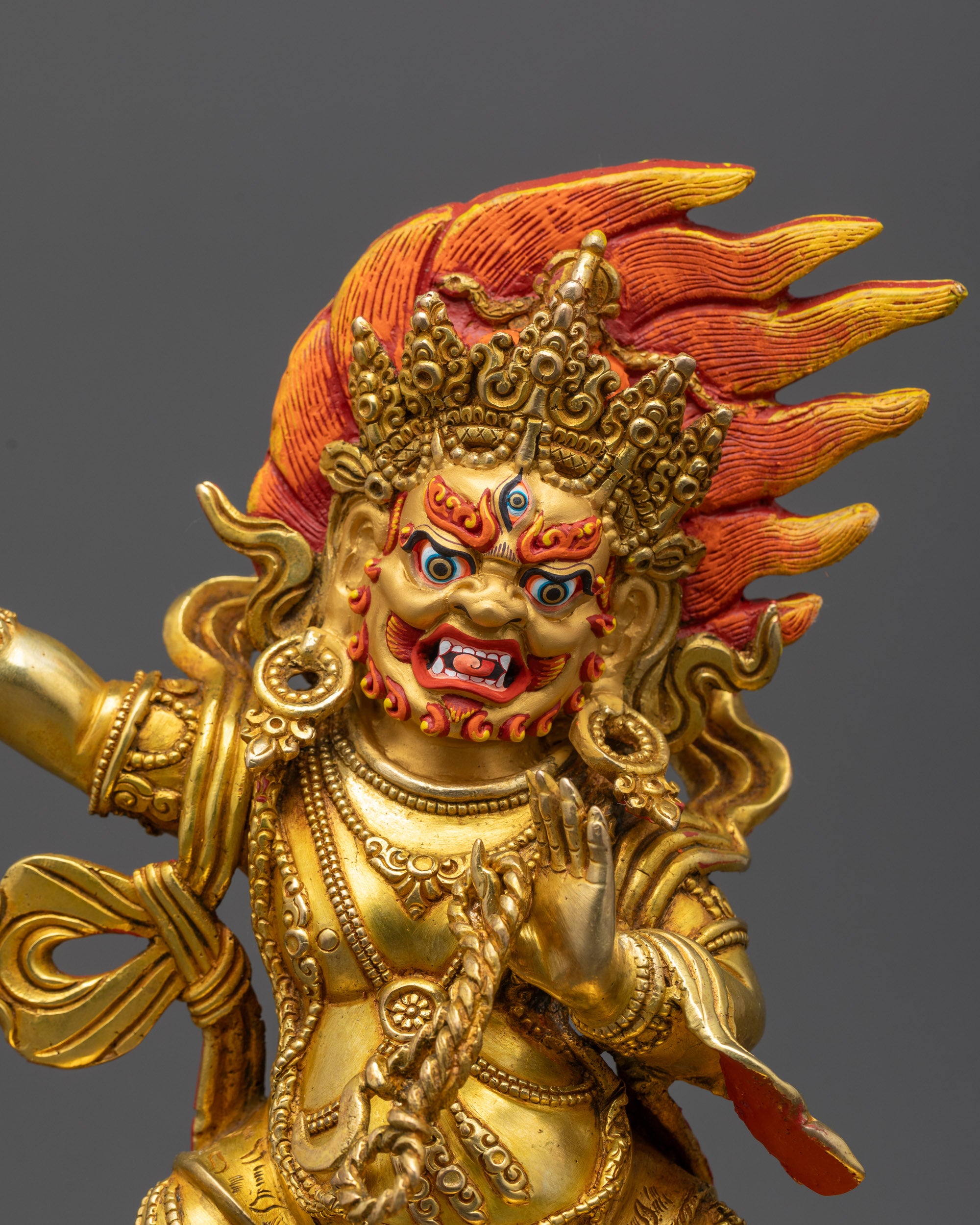 close up Vajrapani statue showing wrathful expression and third eye with intricate details