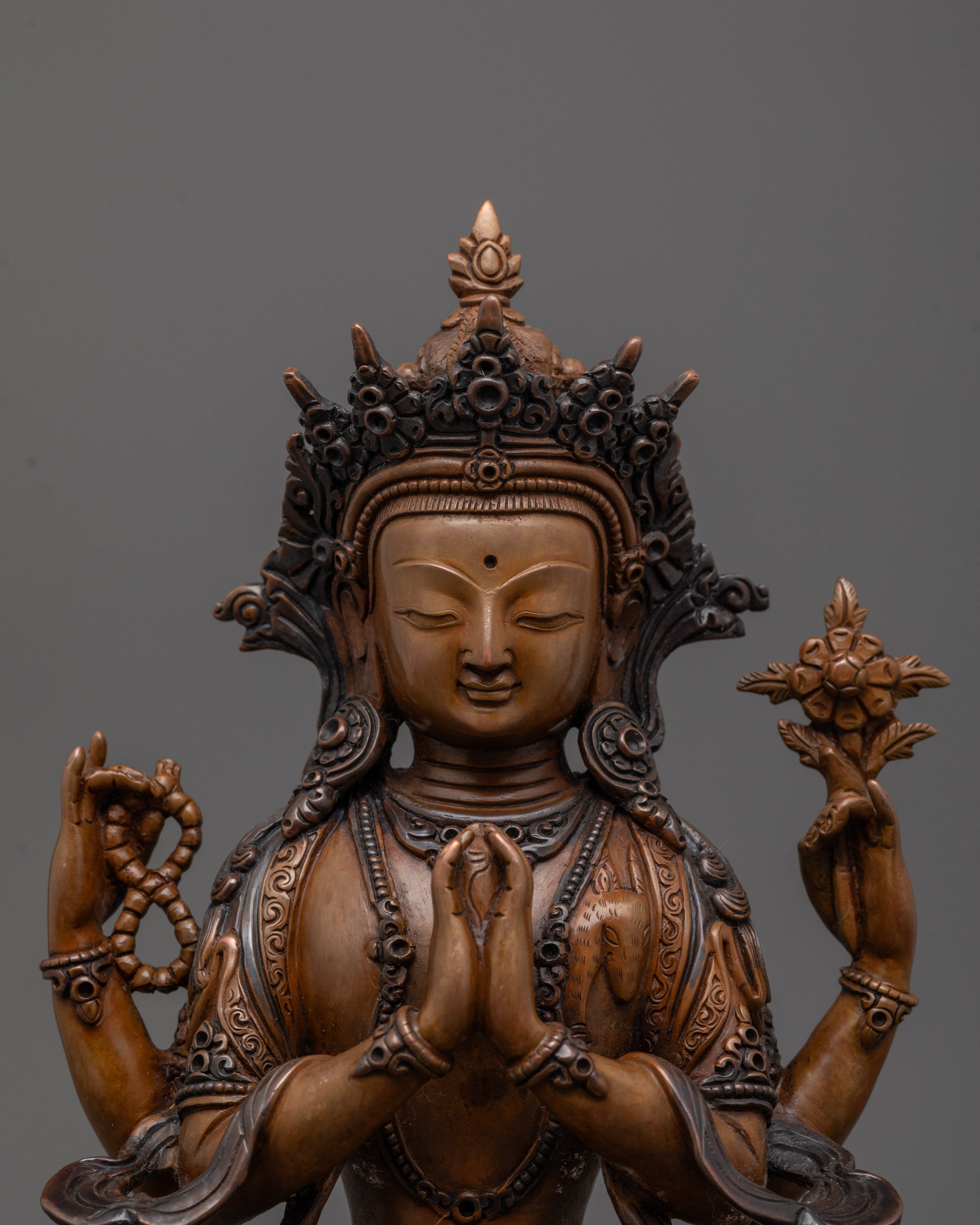 close up of Avalokiteshvara face with two-toned oxidized copper and carved crown detail