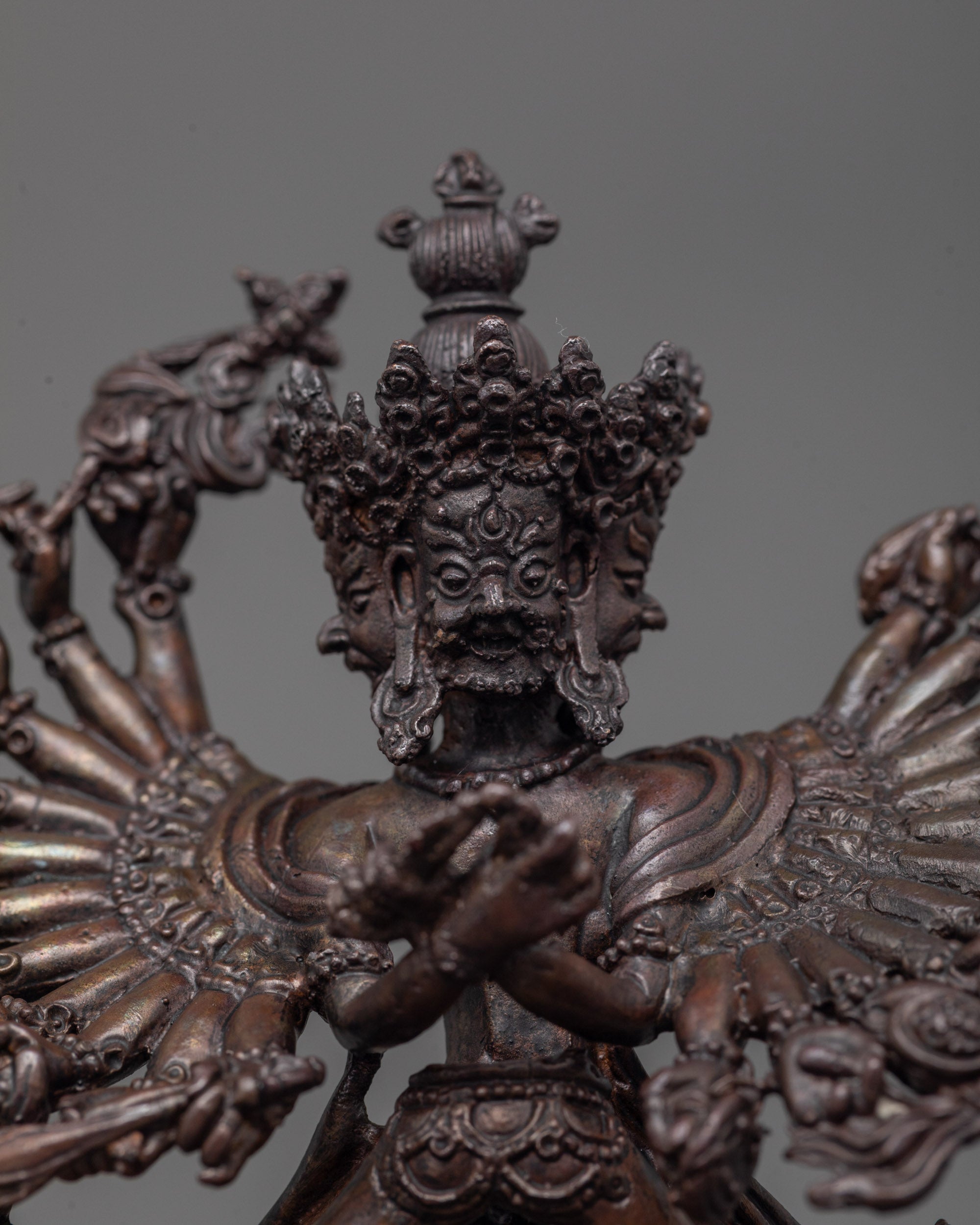 close up of fierce face and skull crown on machine-made oxidized Kalachakra statue