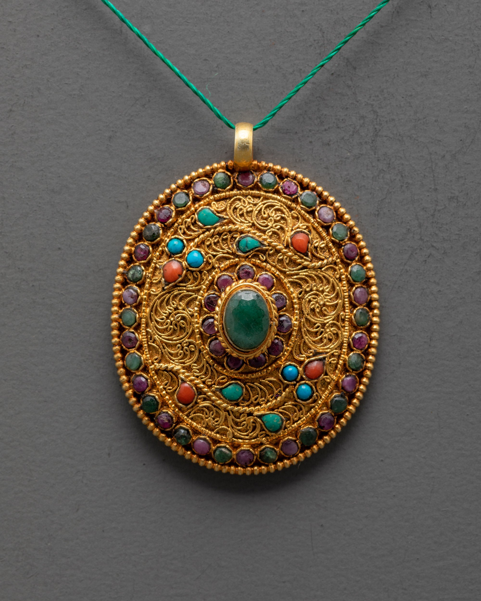 close up of intricate filigree work on authentic Nepalese flower locket pendant with stones