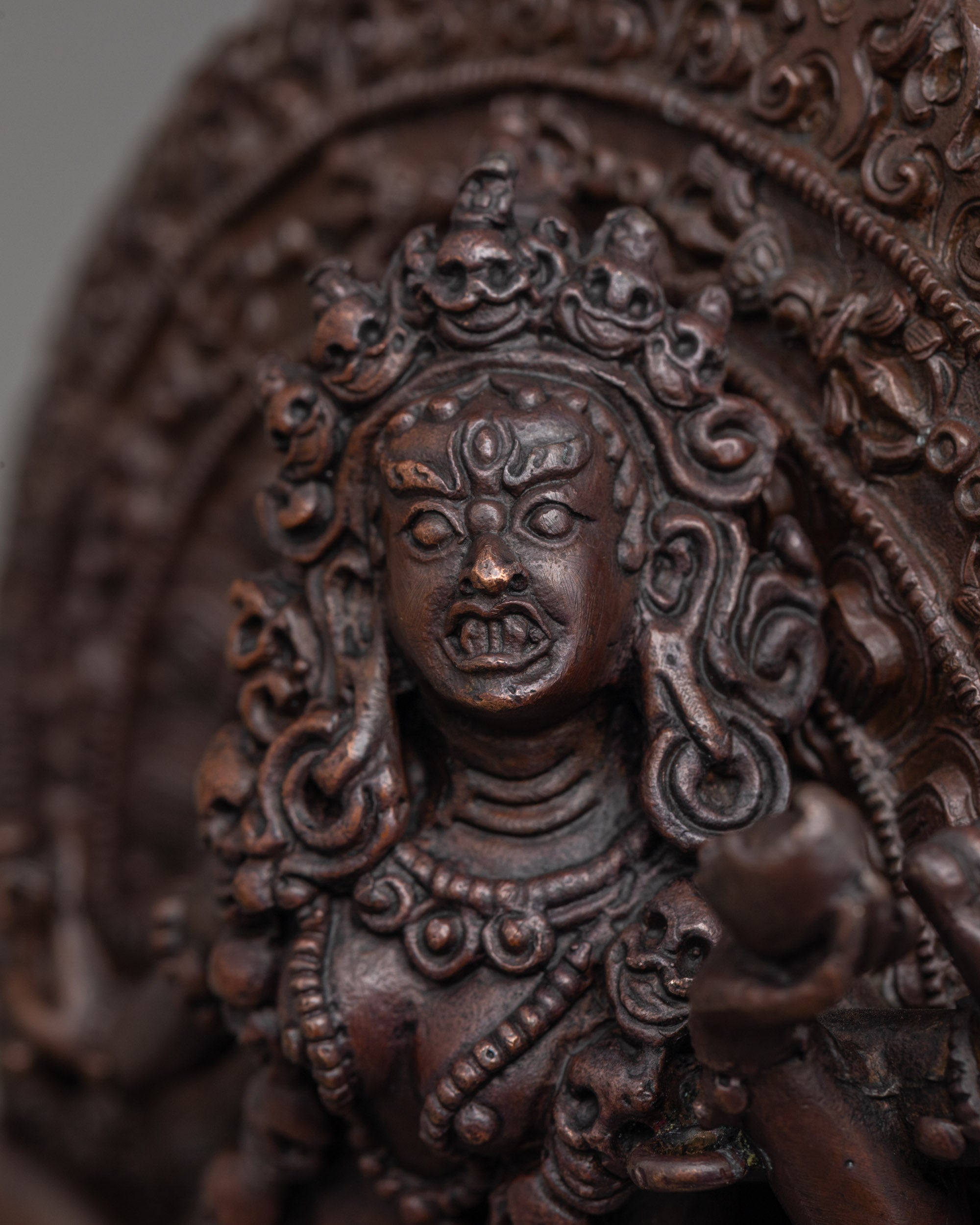 close up of wrathful face and Mundamala garland on machine-made oxidized Vajrayogini statue