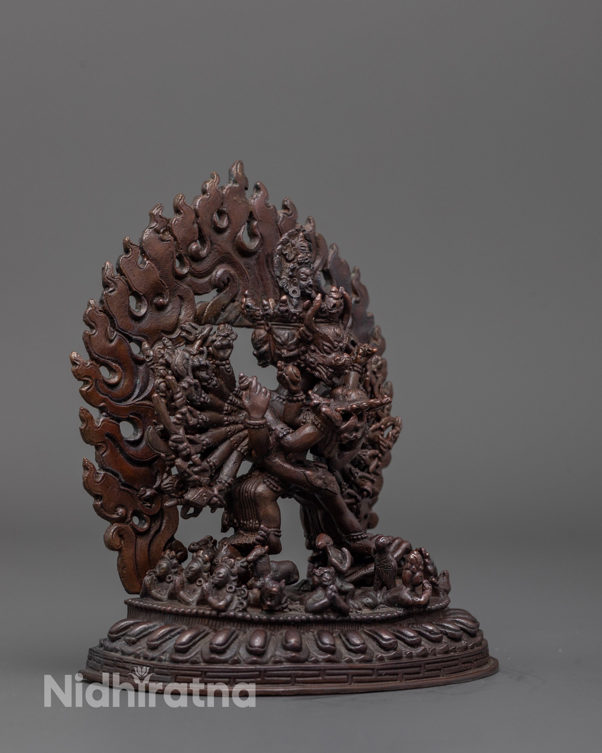 close up of yamantaka statue showing oxidized copper face and detailed sacred objects