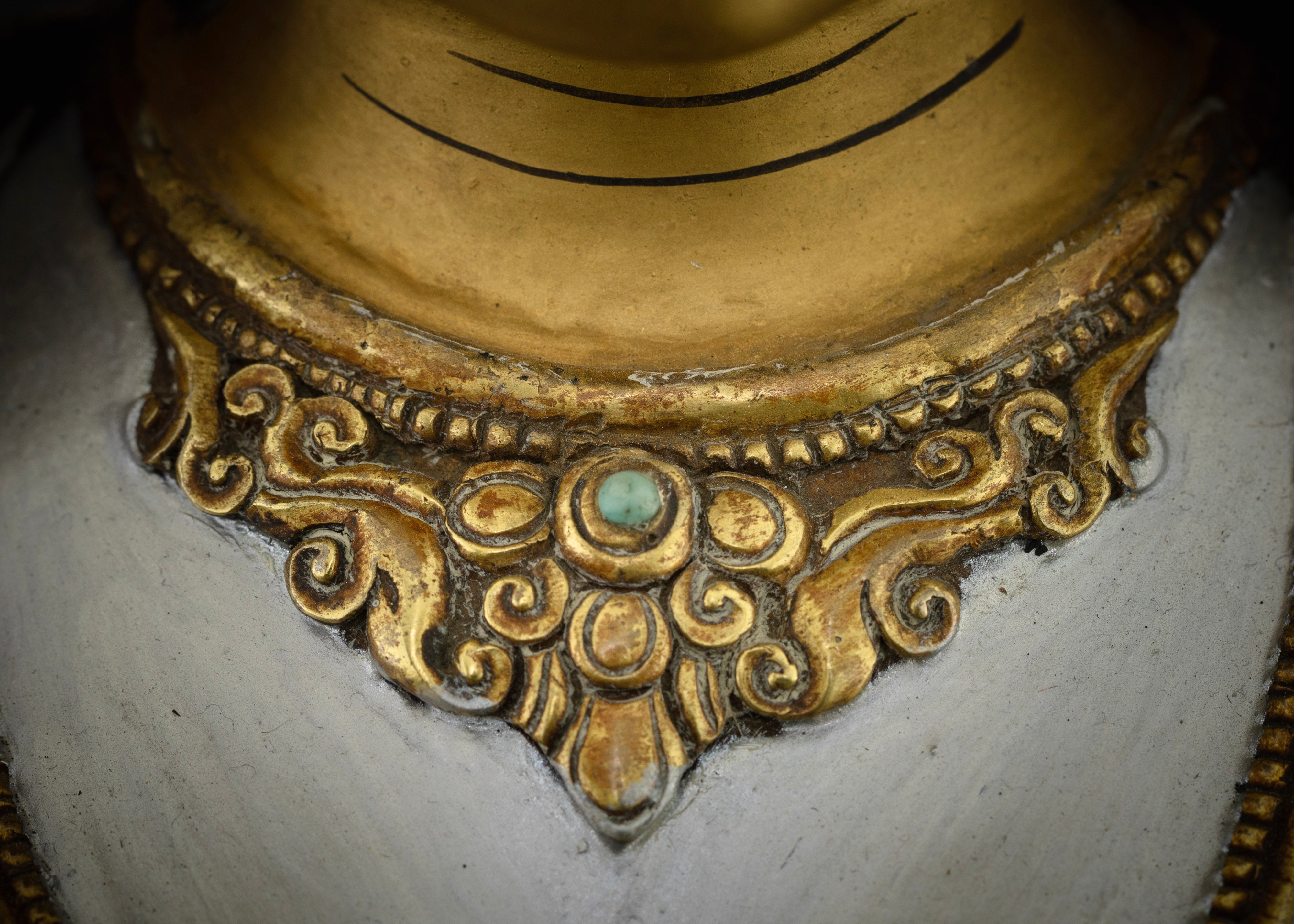 necklace adorned with turquoise of masterpiece colorful white tara statue