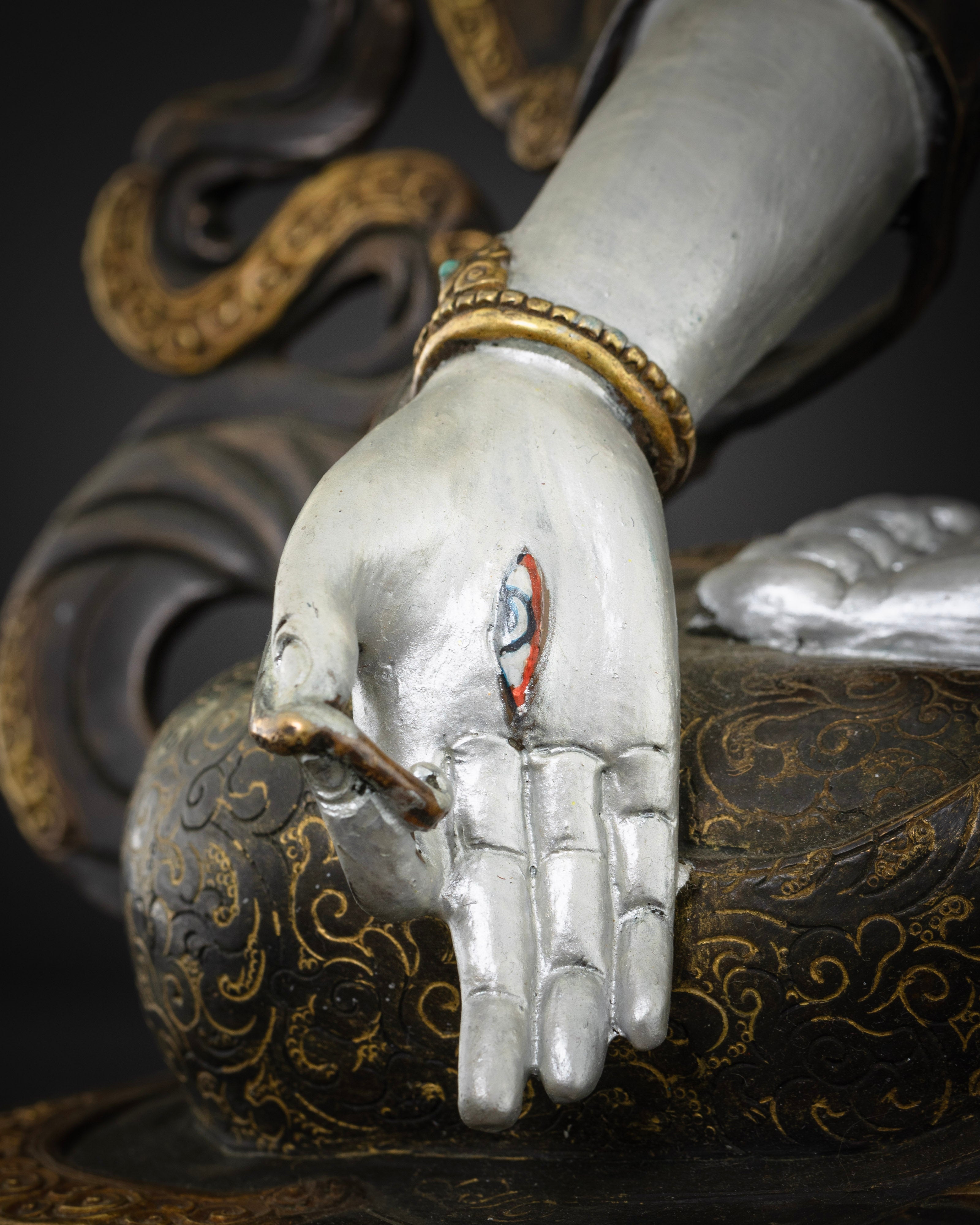an eye in the palm of masterpiece colorful white tara statue