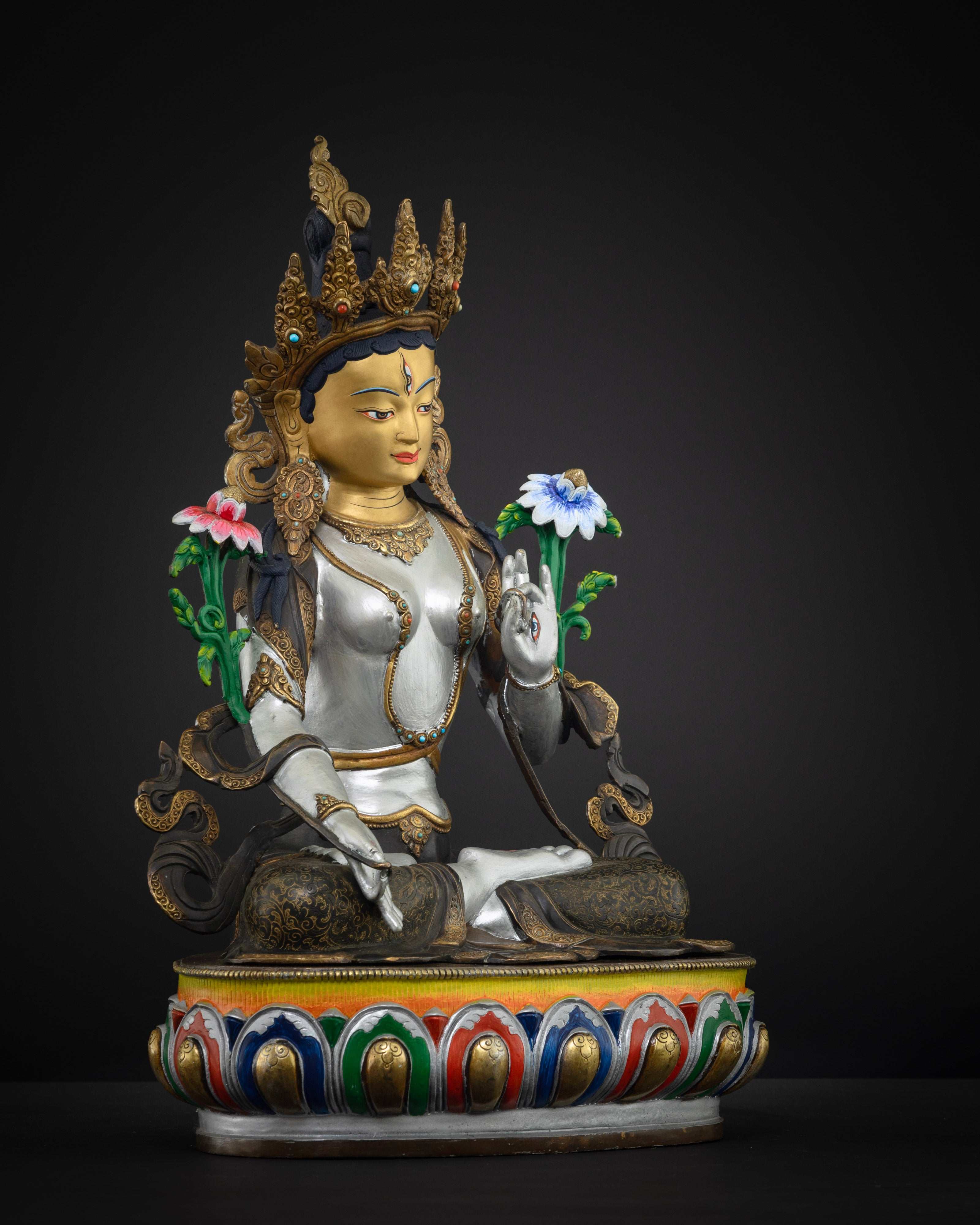 another side view of colorful white tara statue with bright white, red, blue, green colors and gold plated face