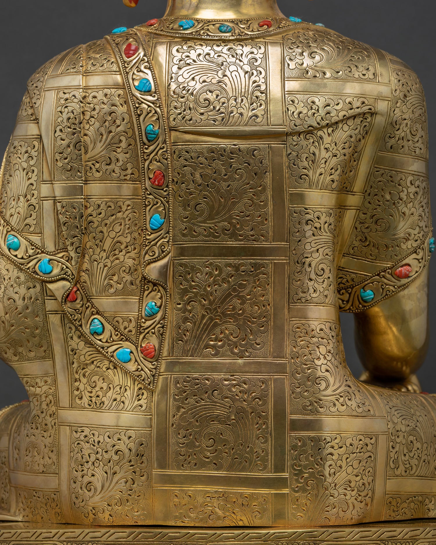 Detail of hand-chased floral filigree on Buddha statue's back robe