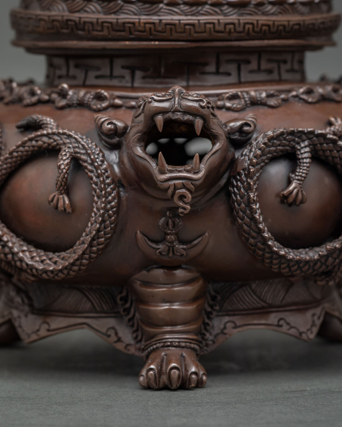 Detail of Vajradaka seated on lotus base above carved incense burner