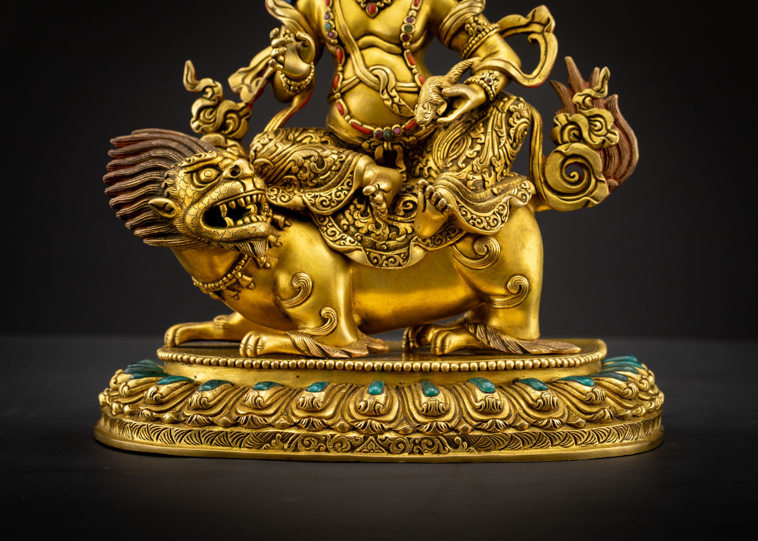 Detail view Namtoshe holding jewel spitting mongoose symbolizing prosperity transformation and protection in sacred Buddhist art