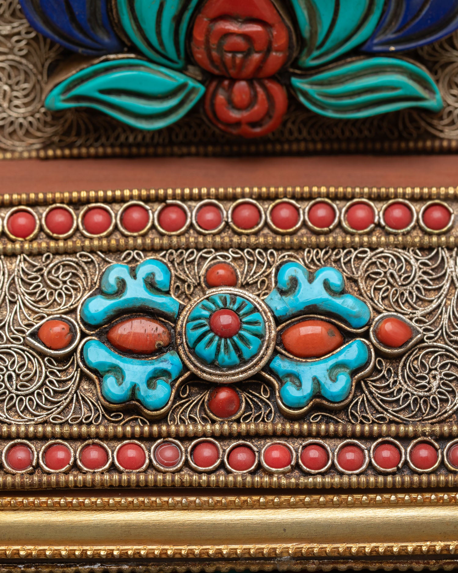 Detail view of lower mandala showing Vajra symbol finely designed in copper gold plated artwork representing strength wisdom and spiritual power