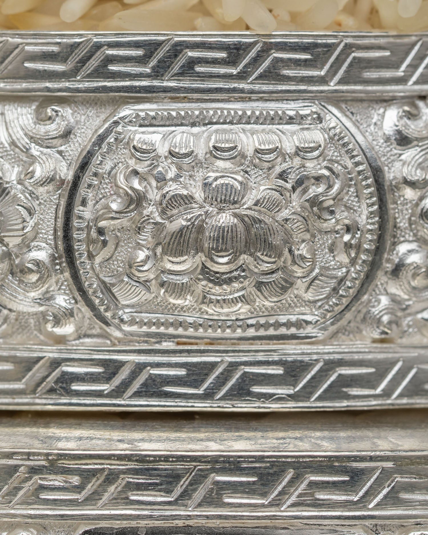 Detail View of Upper Tiers of Silver Buddhist Mandala Offering Set Filled with Traditional Grains