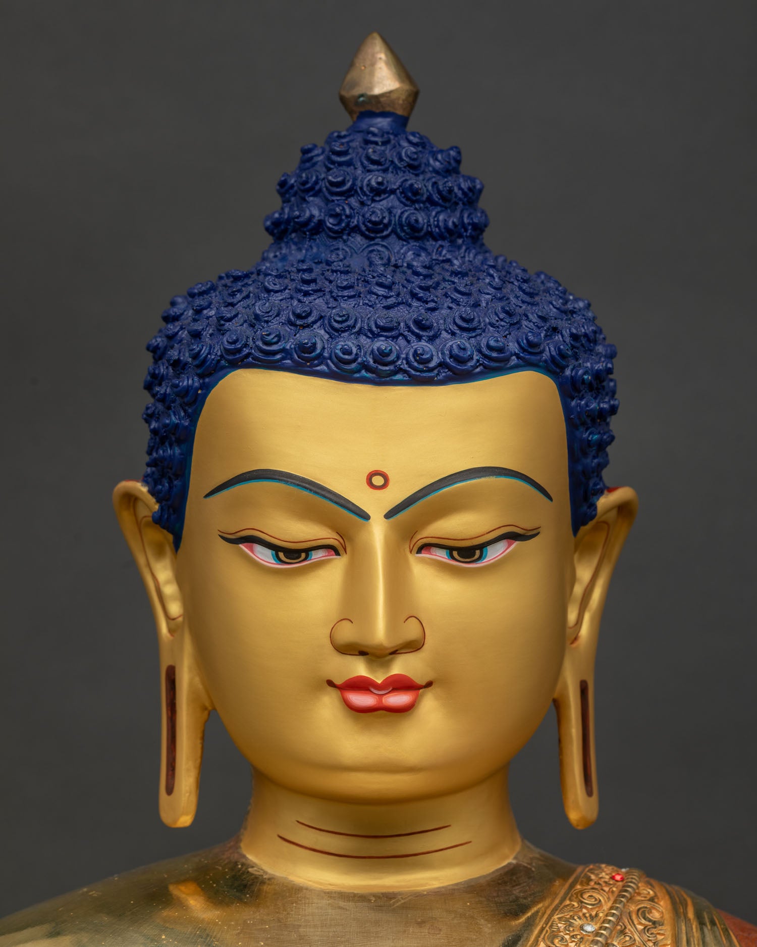 Detailed close-up of Amitabha Buddha face – serene gold-painted expression