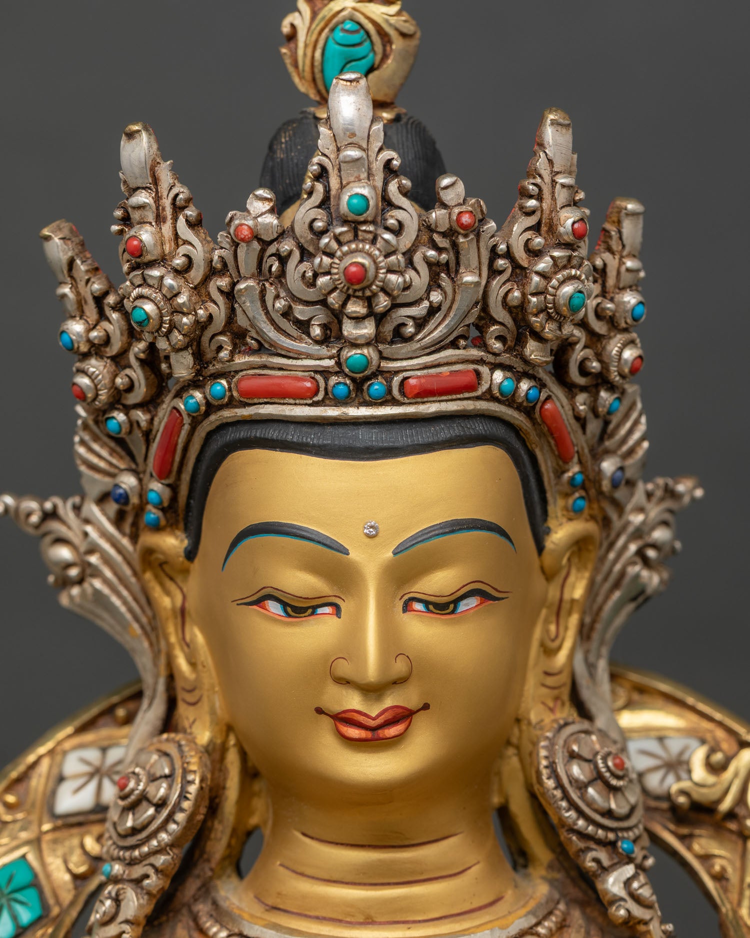 Detailed close-up of Chenrezig face, tranquil expression with gold-painted features